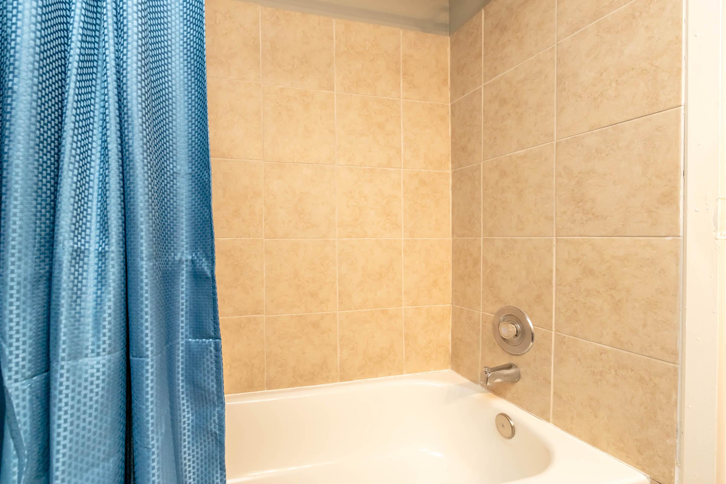 a shower curtain next to a tub