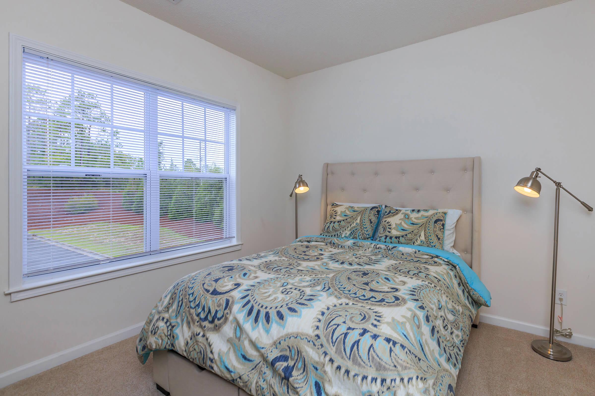 a bedroom with a bed and a window