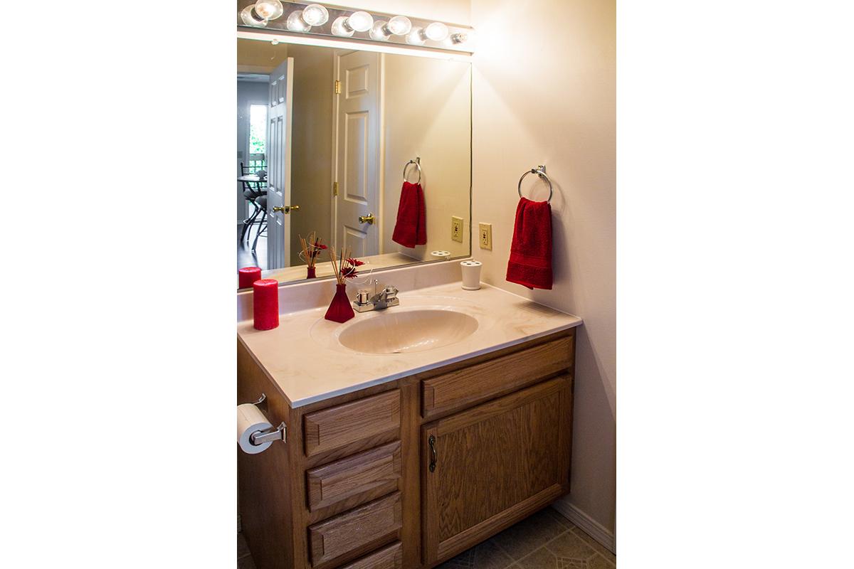 a kitchen with a sink and a mirror