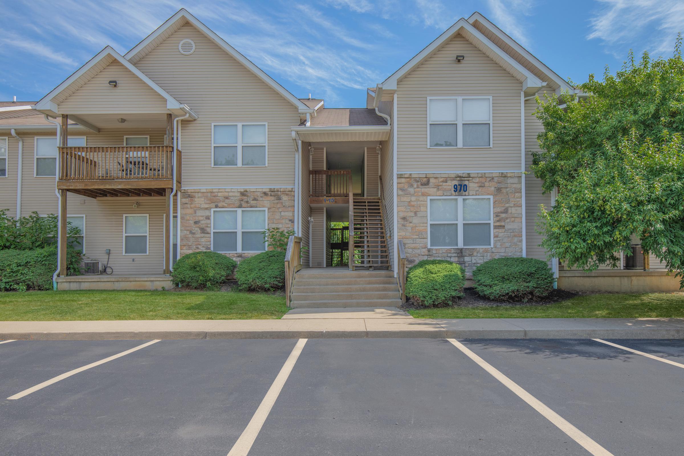 Entrance and parking lot at Bloom apartments in Bloomington IN