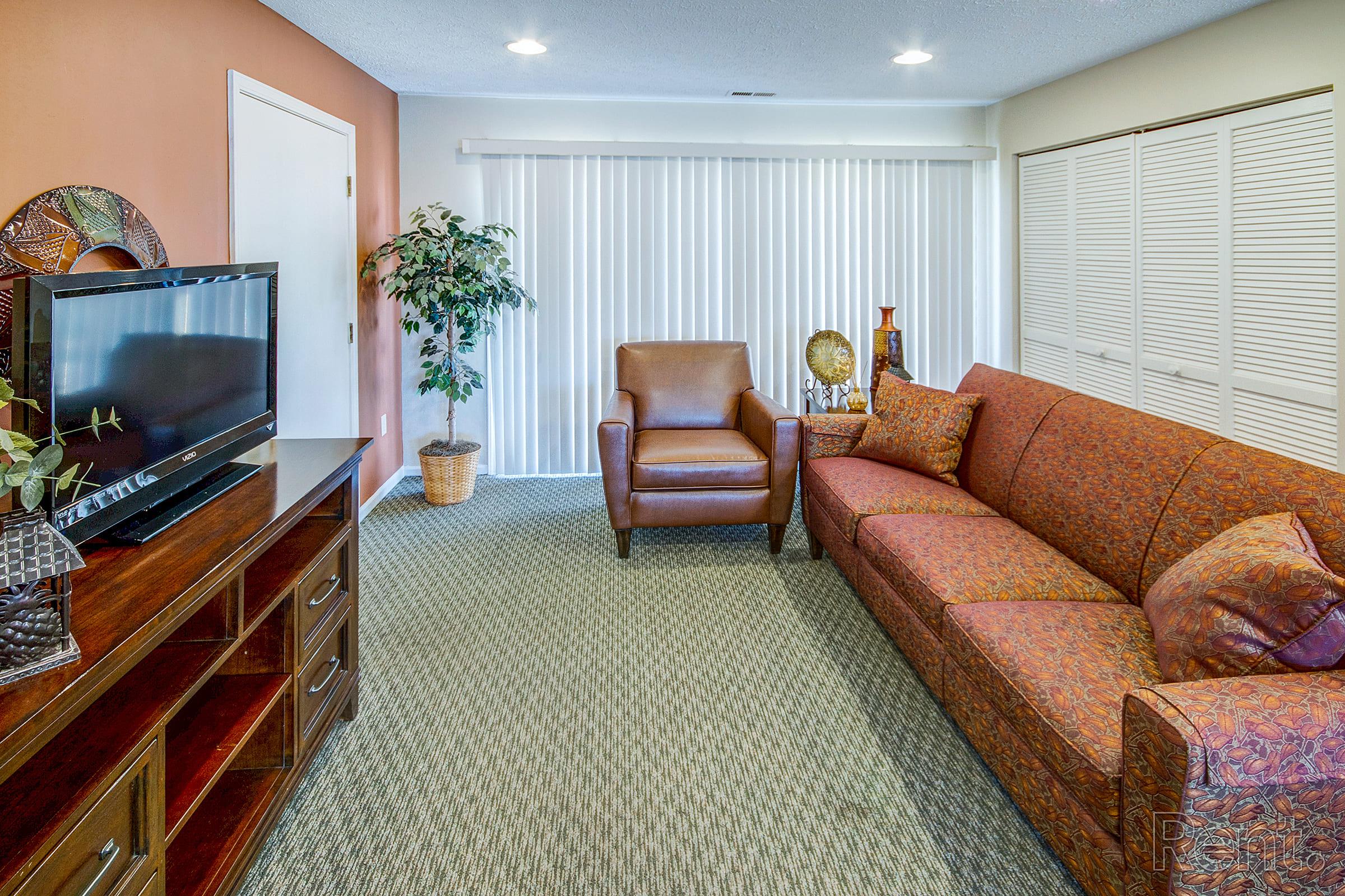 a living room filled with furniture and a large window