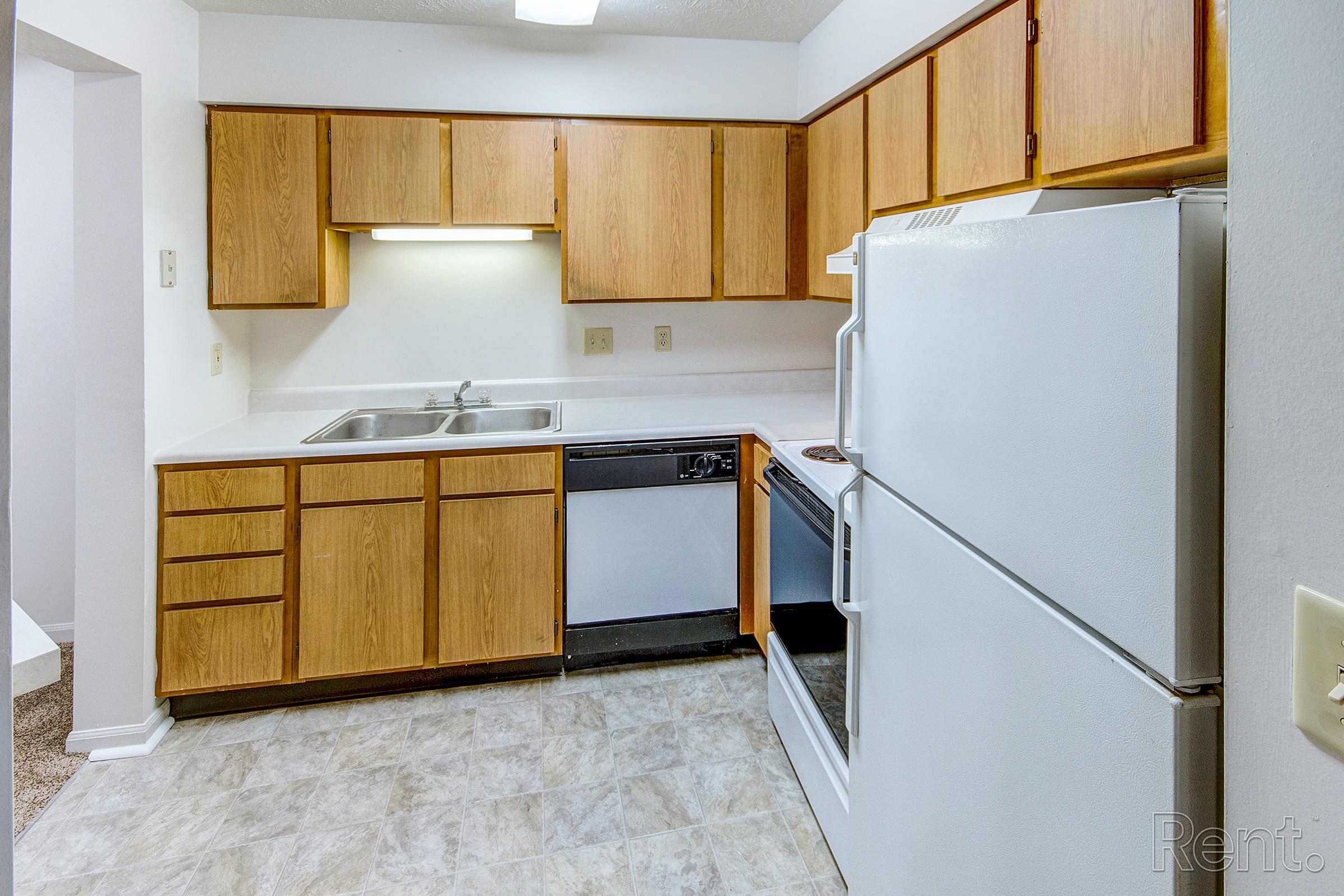 a kitchen with a stove and a refrigerator