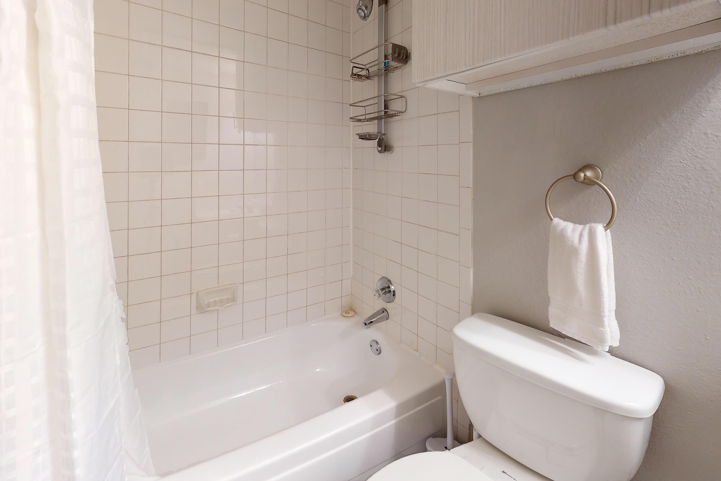 a furnished bathroom with a white shower curtain