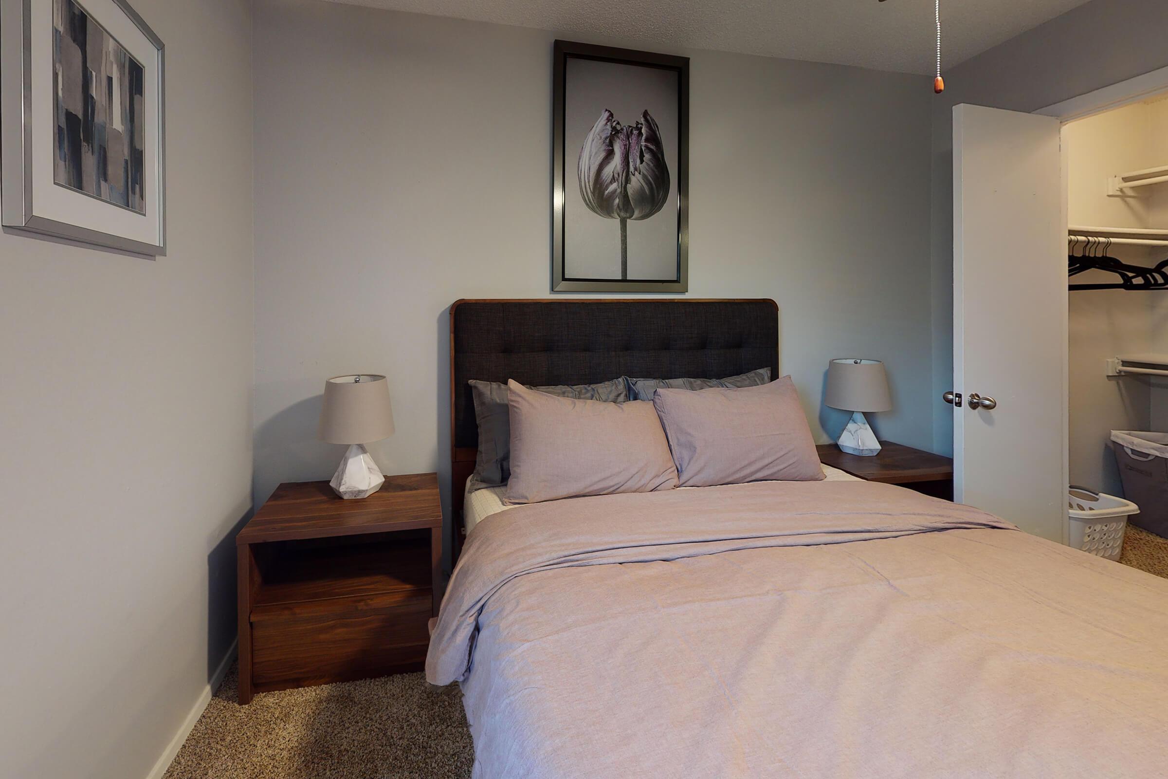 a furnished bedroom with wooden night stands
