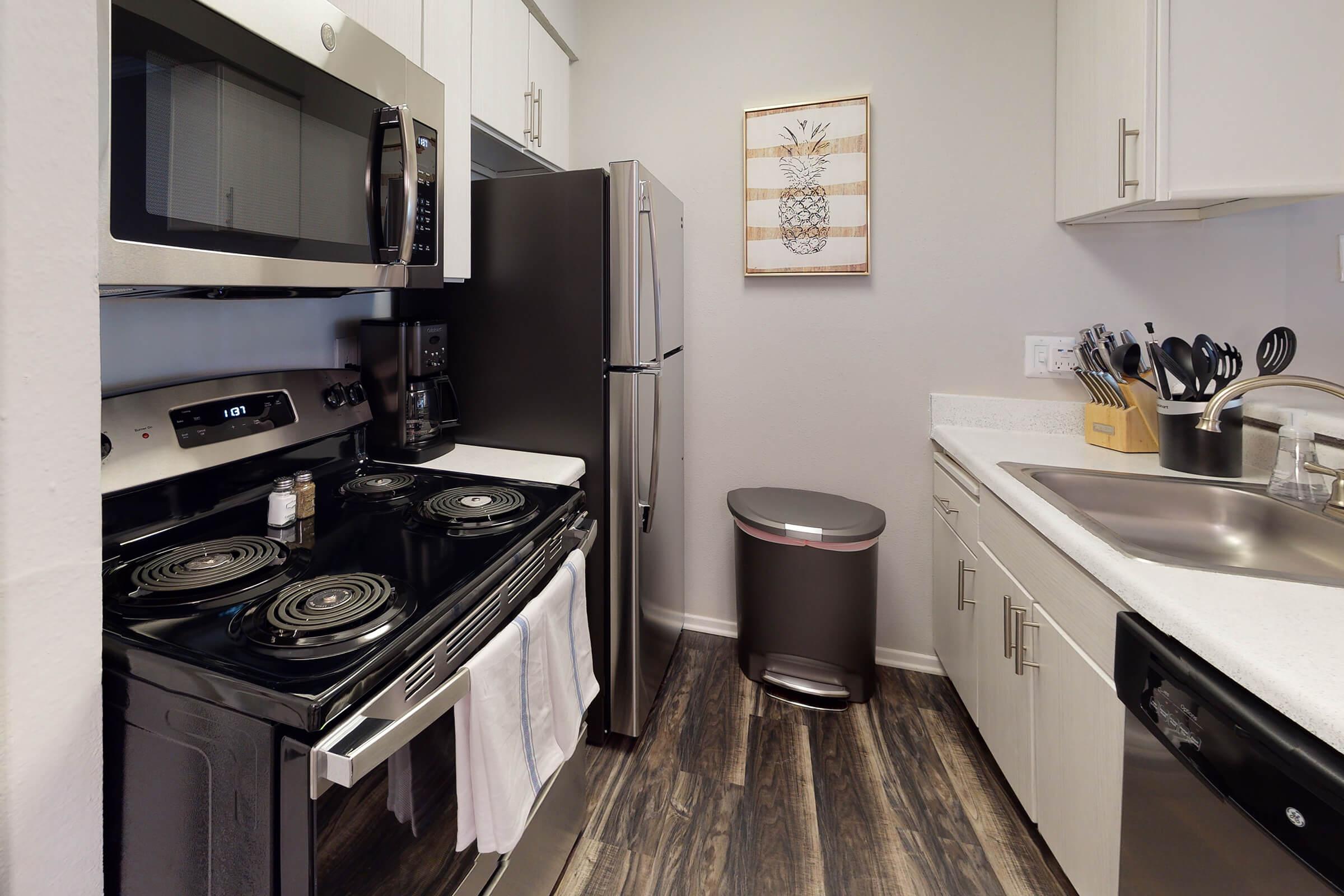 a furnished kitchen with stainless steel appliances