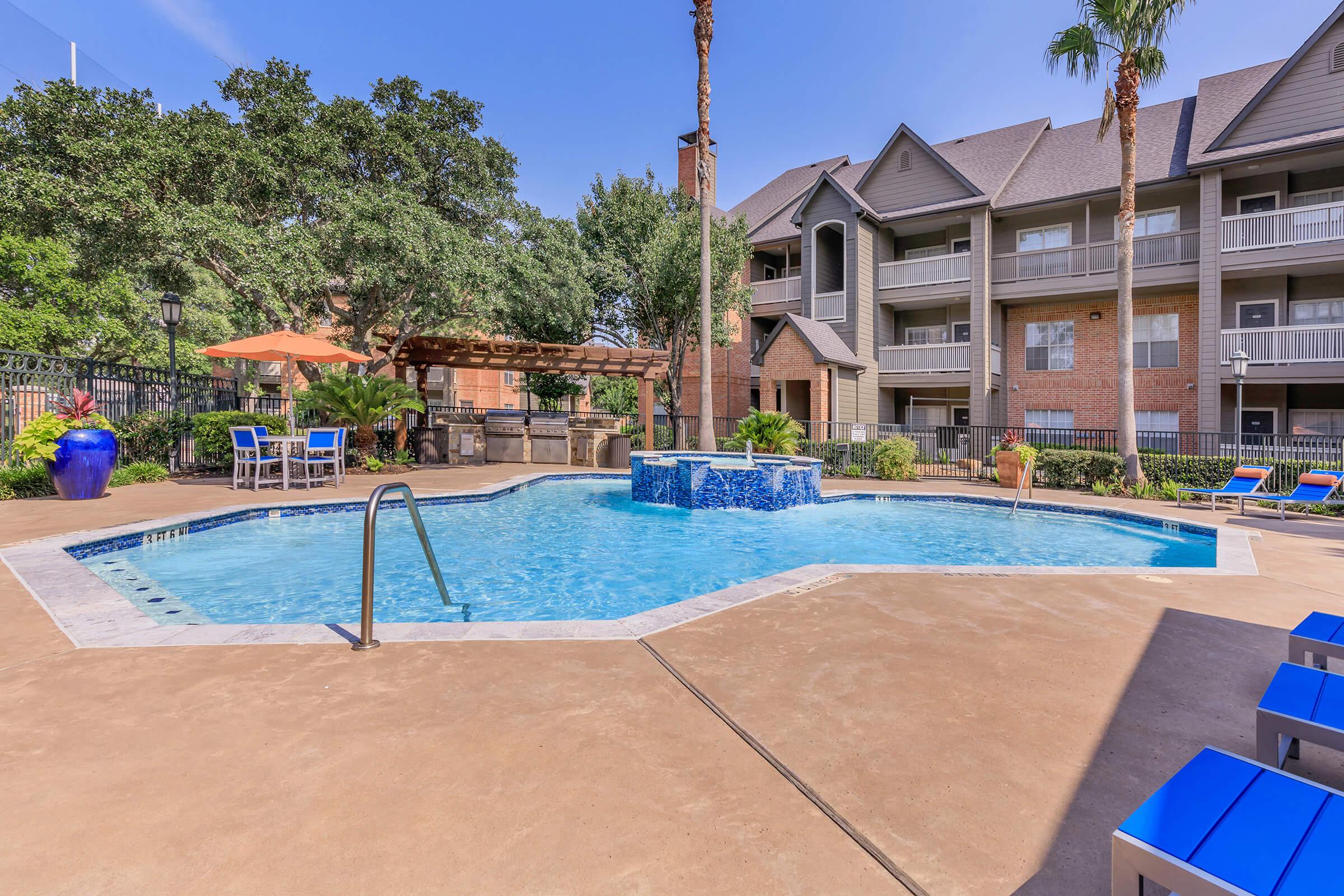 a house with a pool in front of a building