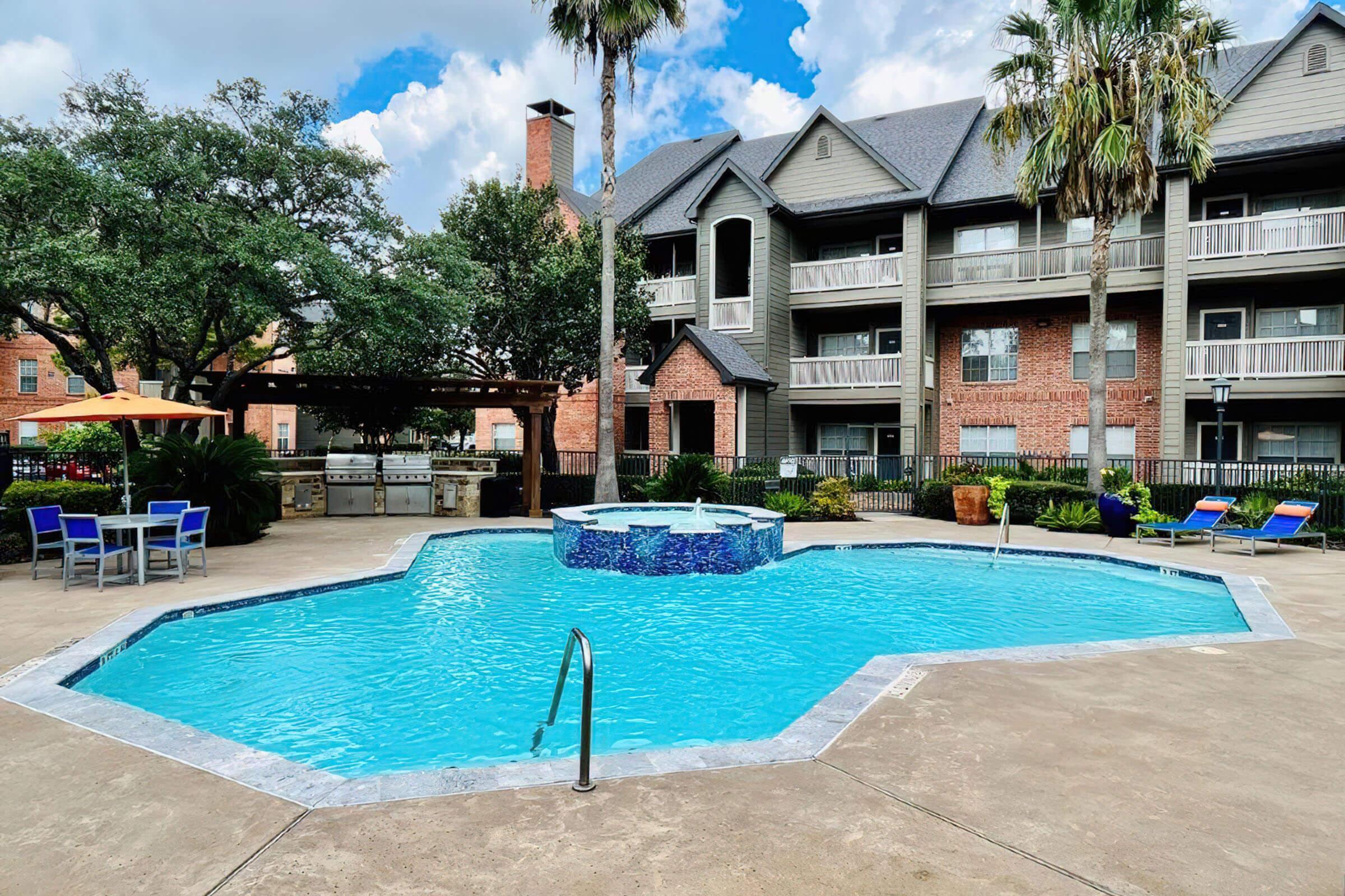 the community pool with green trees