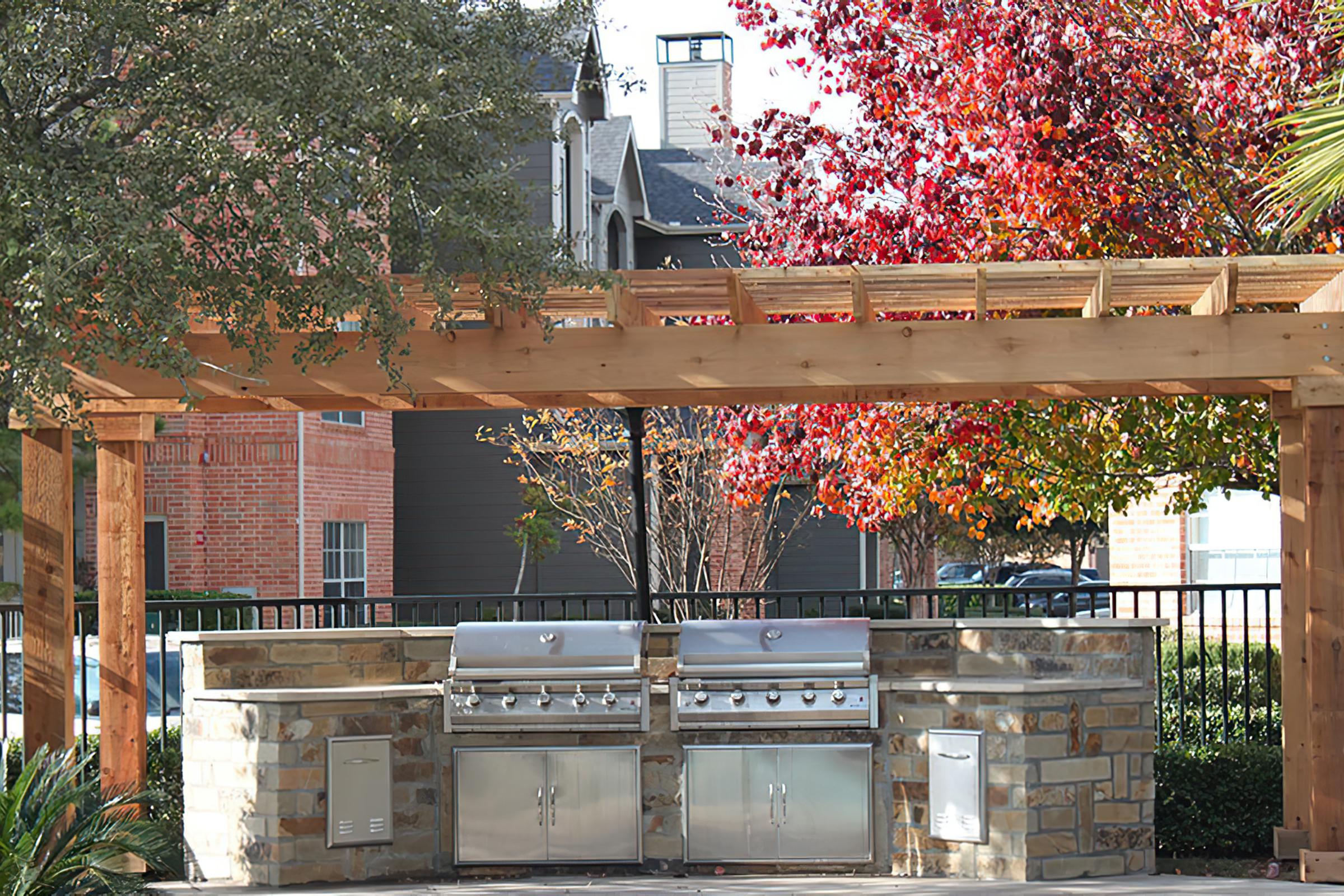 stainless steel barbecues under a pergola