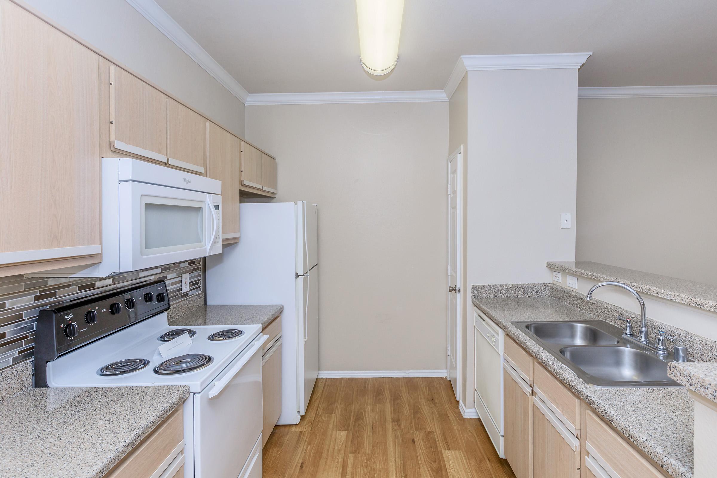 a kitchen with a stove and a sink