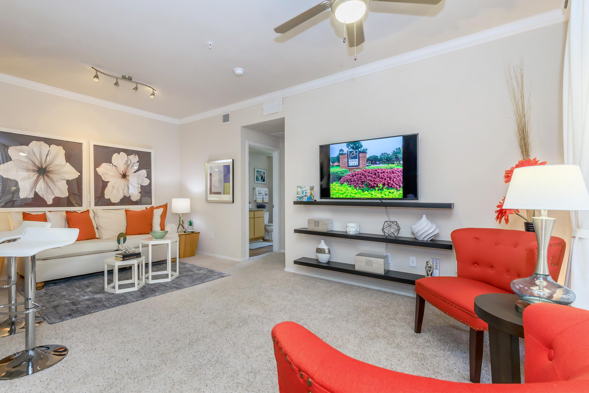 a living room filled with furniture and a flat screen tv