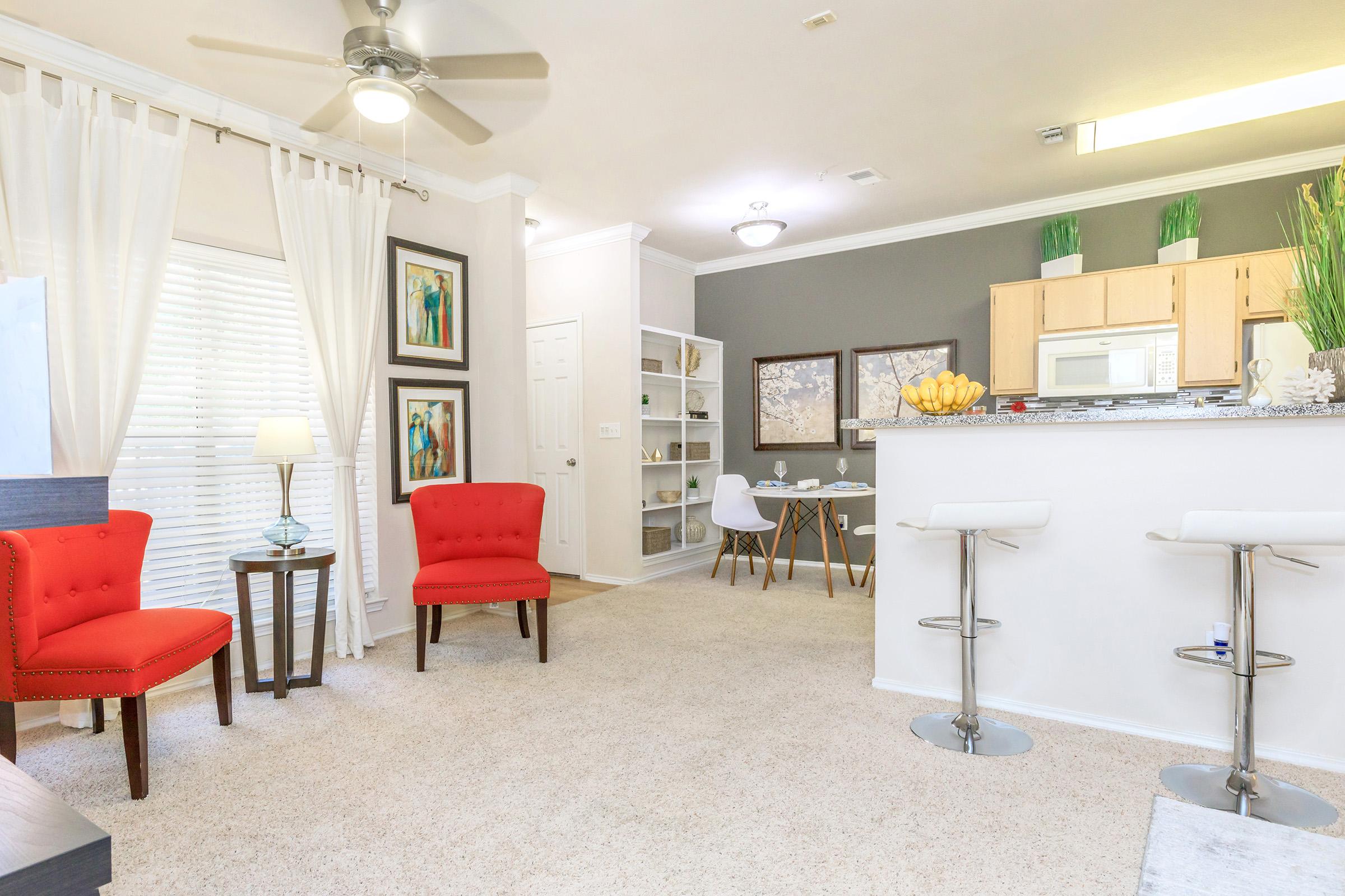 a living room filled with furniture and a table