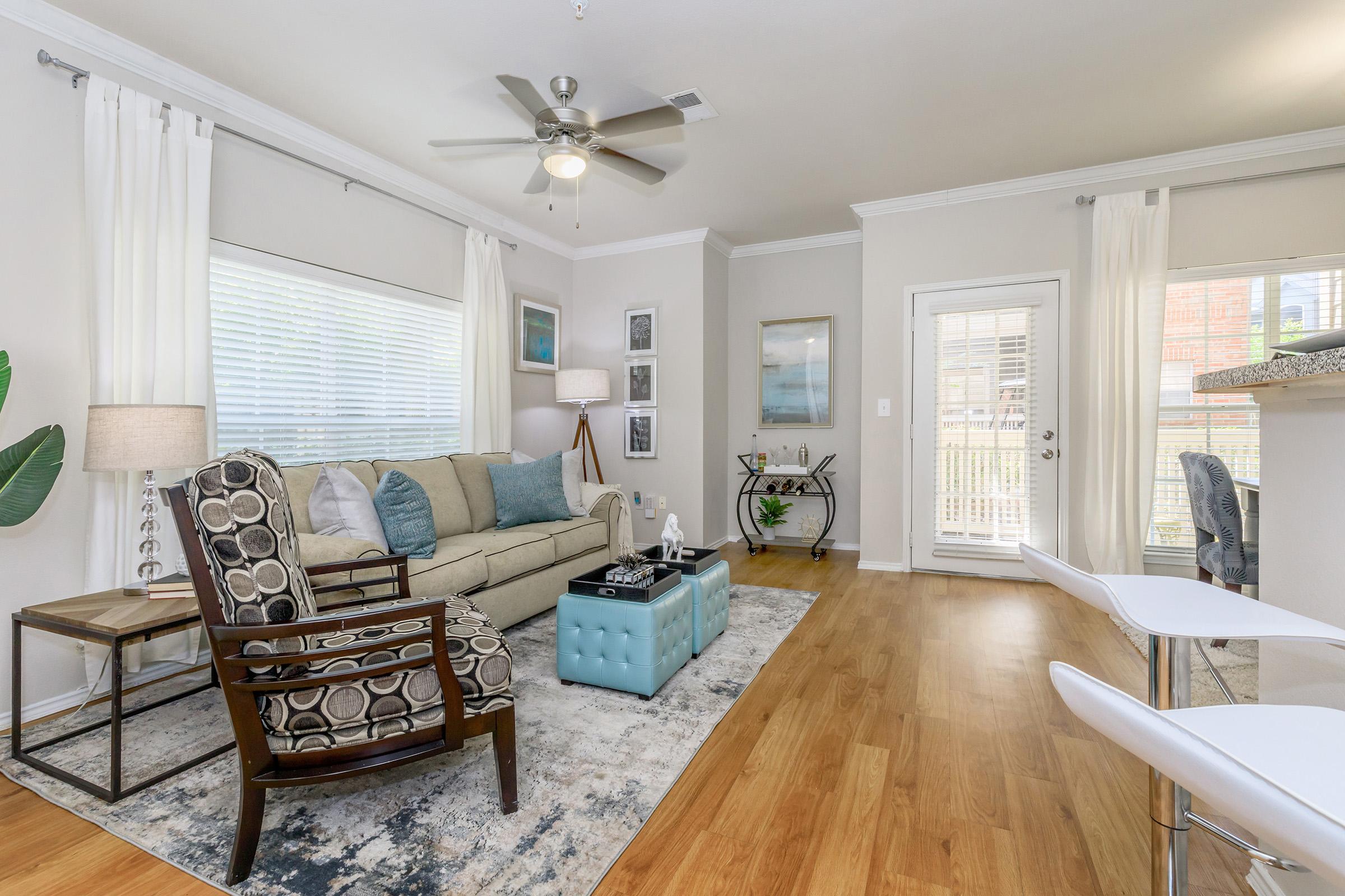 a living room filled with furniture and a large window