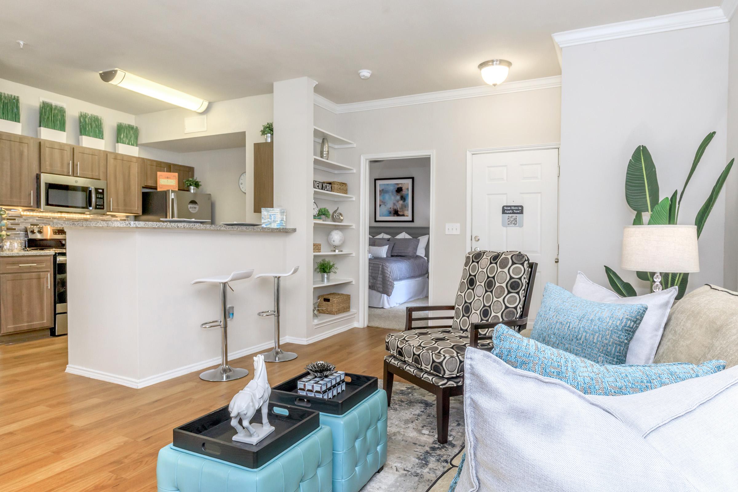 a living room filled with furniture and a refrigerator