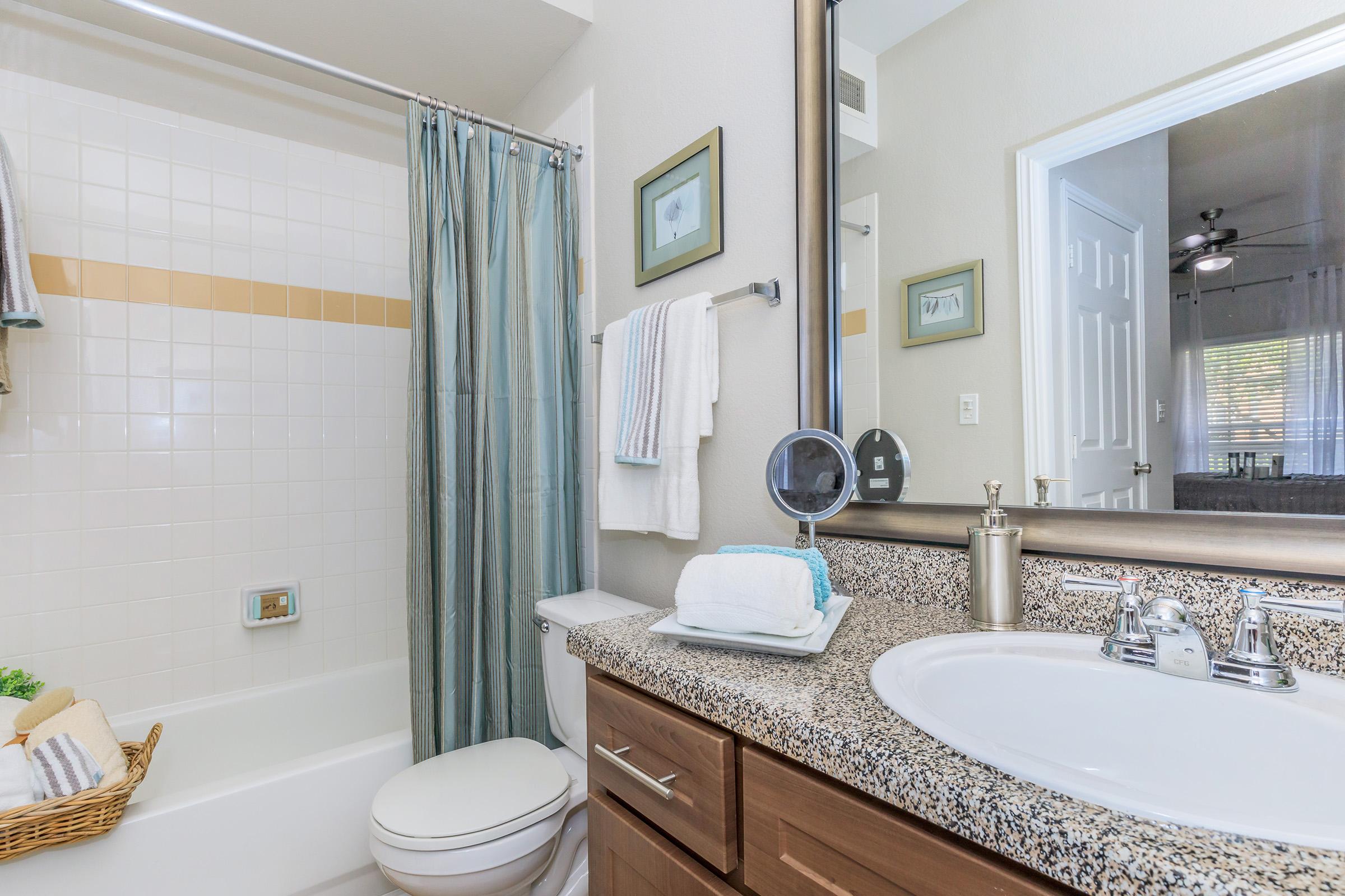 a bedroom with a large tub next to a sink