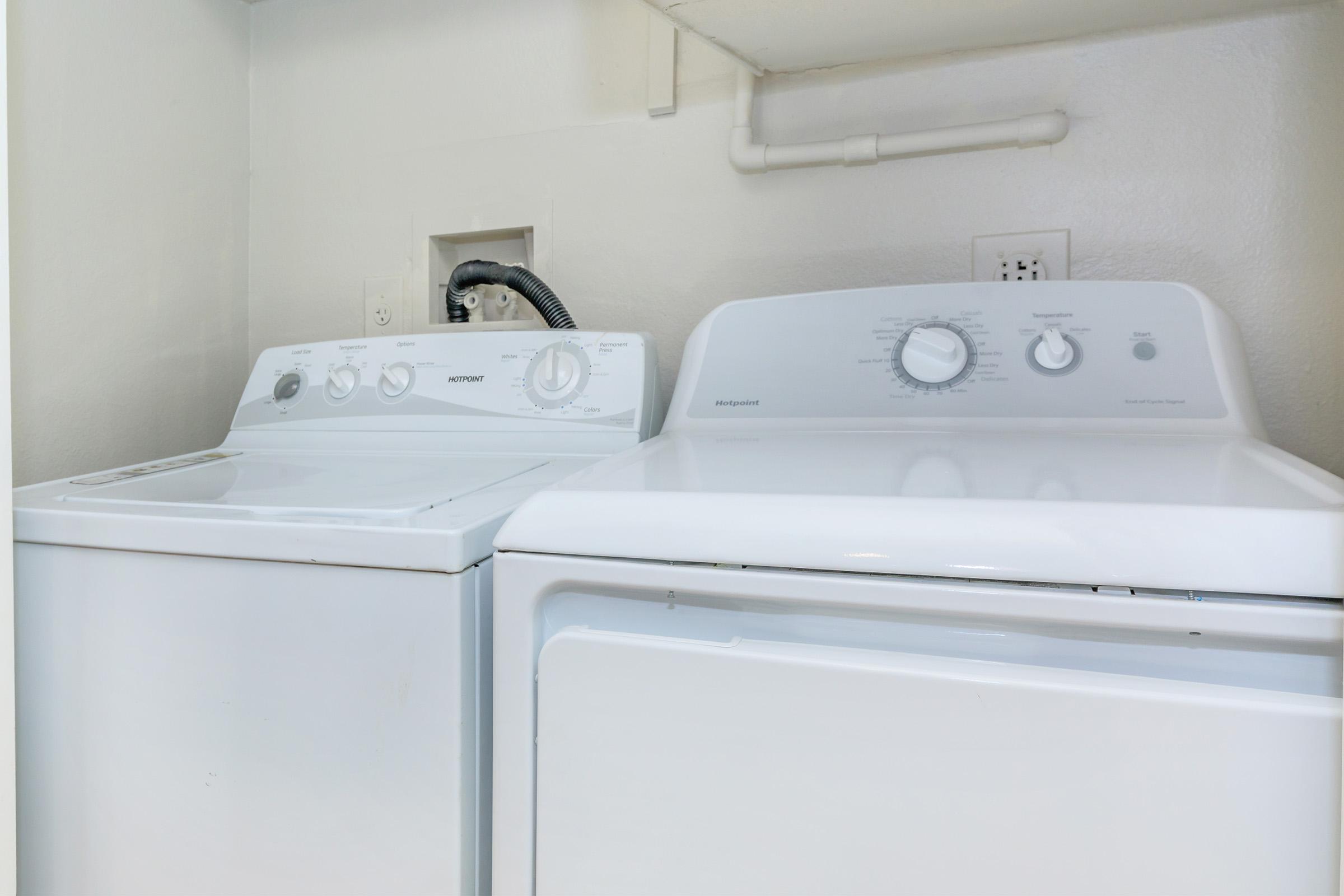 a microwave oven sitting on top of a refrigerator