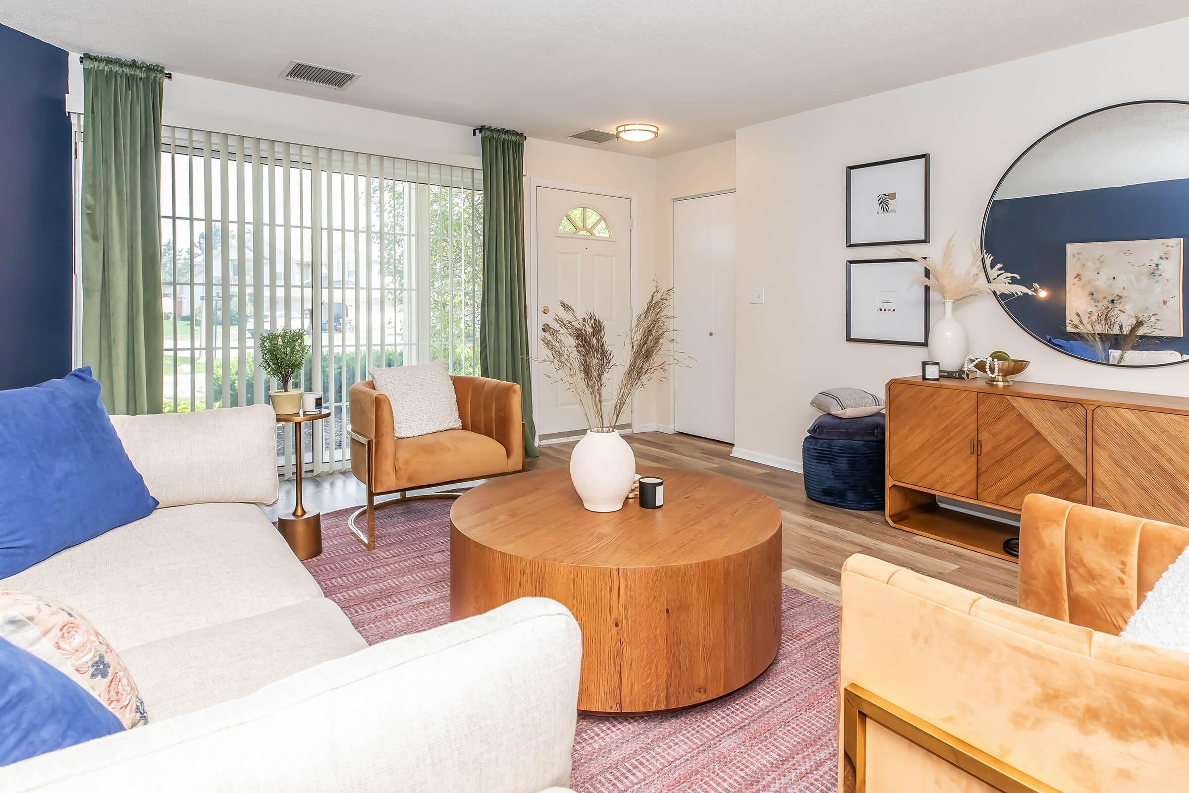 a living room filled with furniture and a bed