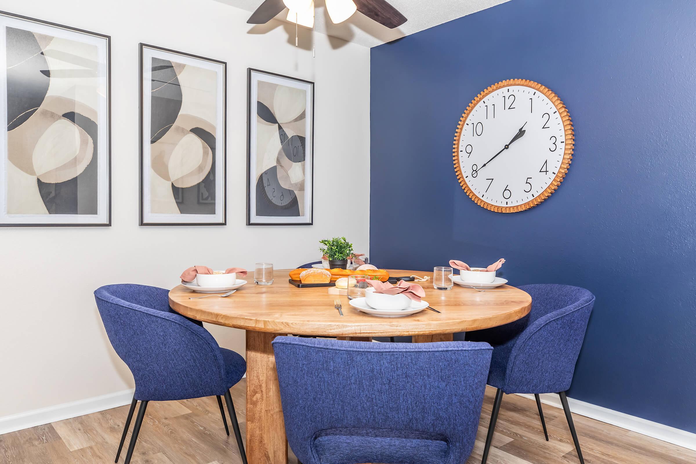 a group of people sitting at a table with a blue chair