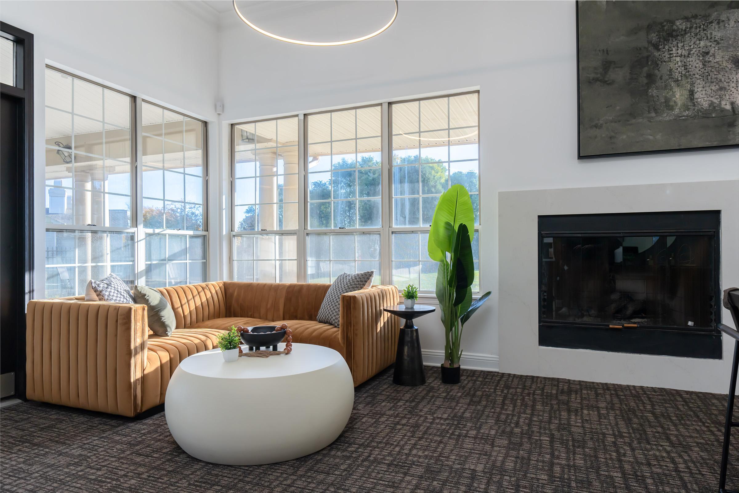 a living room filled with furniture and a large window