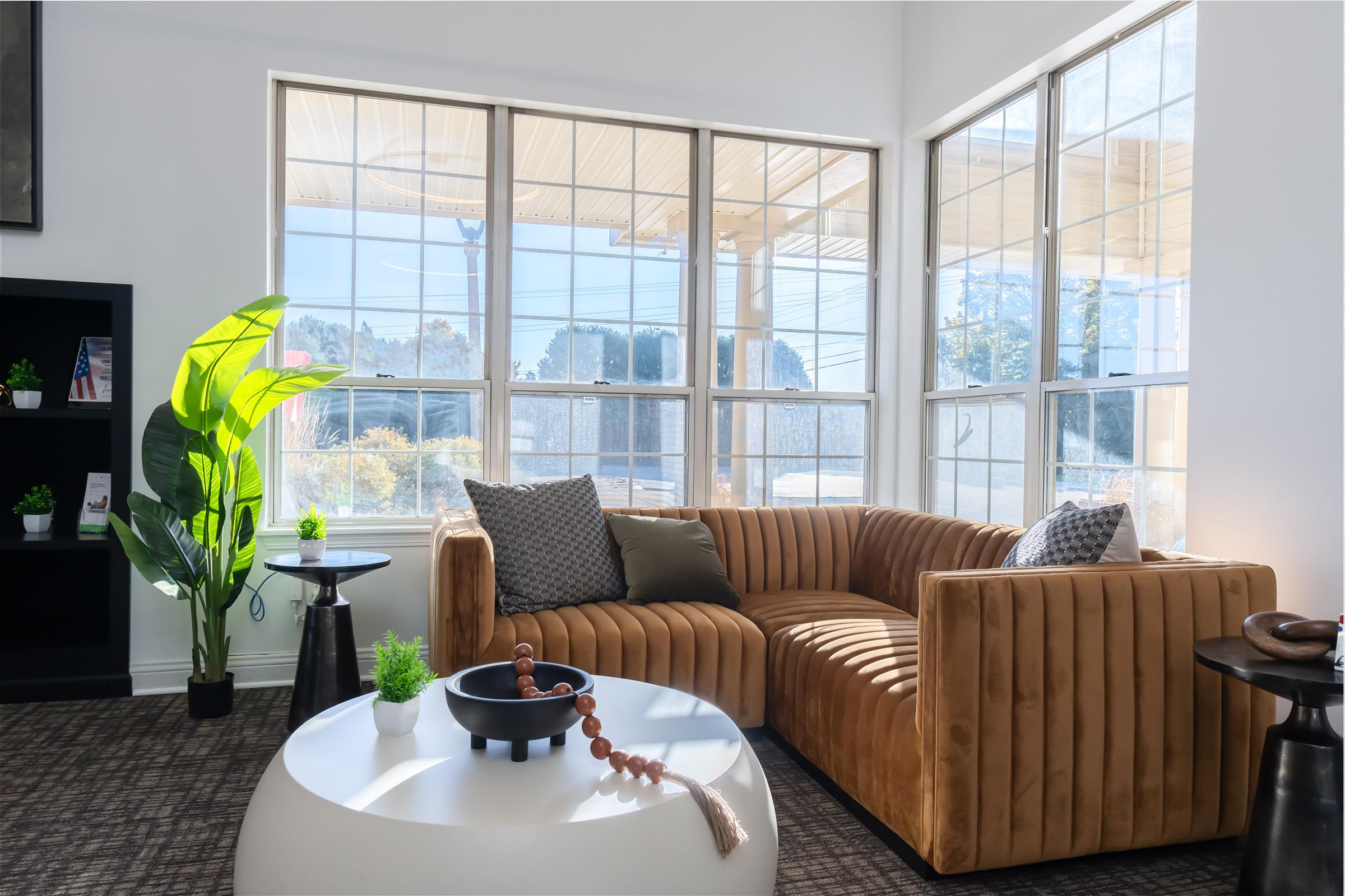 a living room filled with furniture and a large window