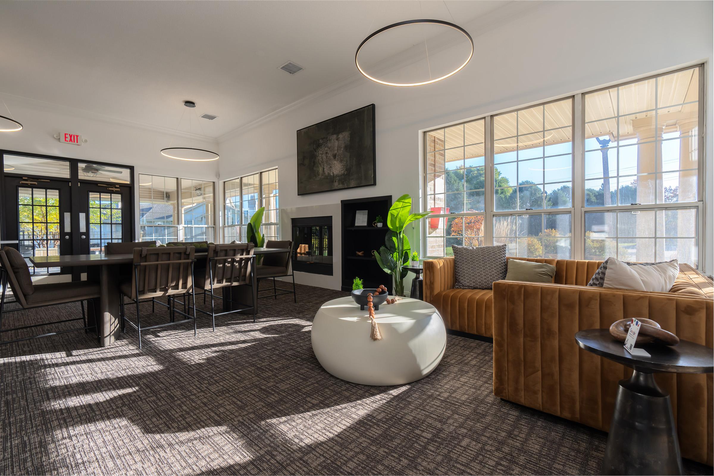 a living room filled with furniture and a large window