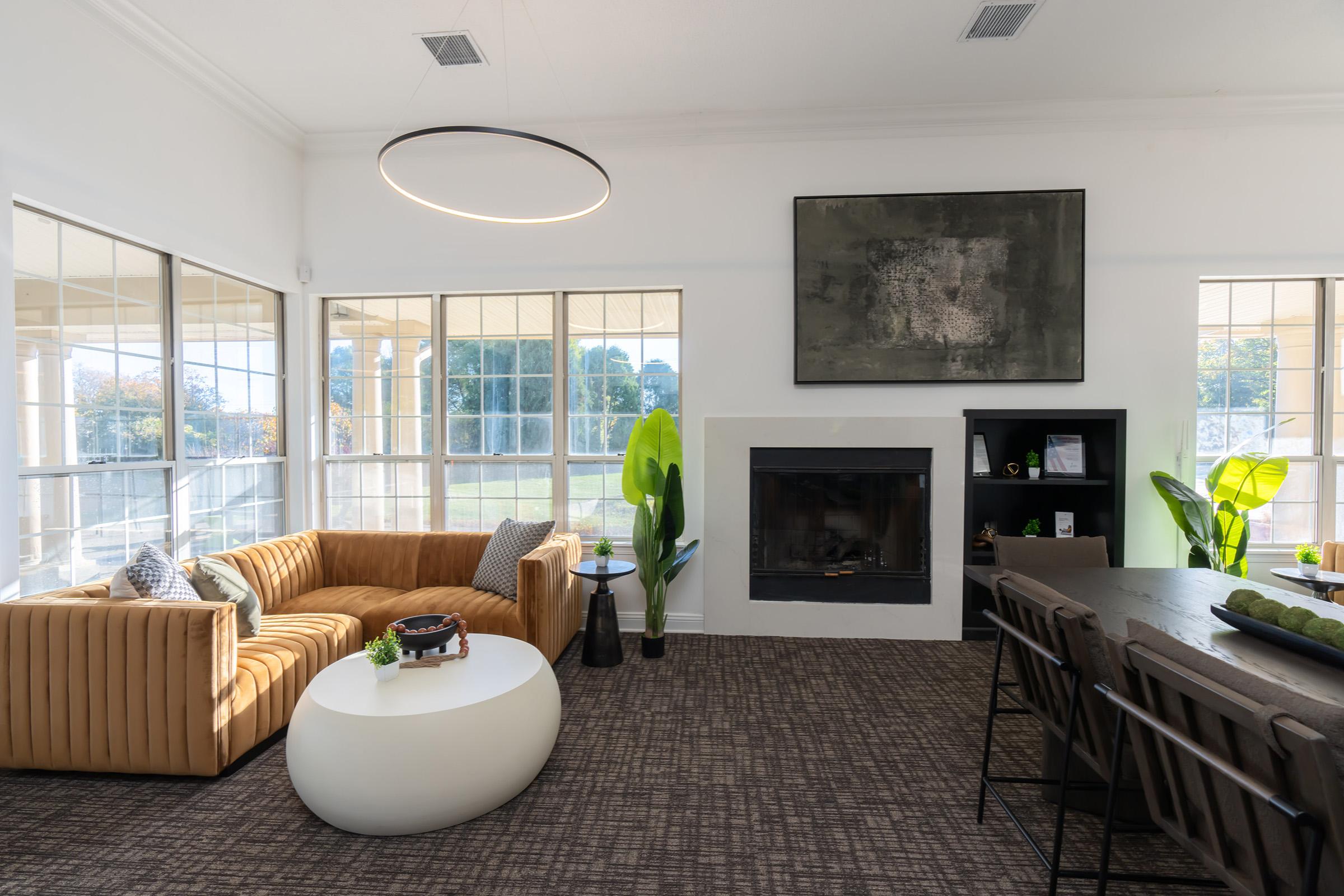 a living room filled with furniture and a large window