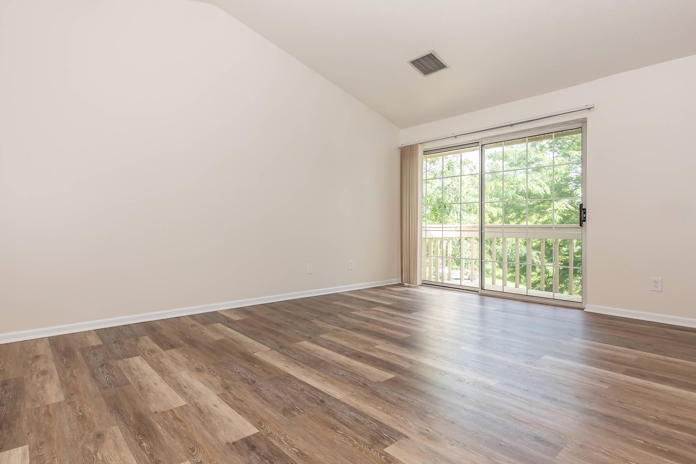 a large empty room with a wooden floor