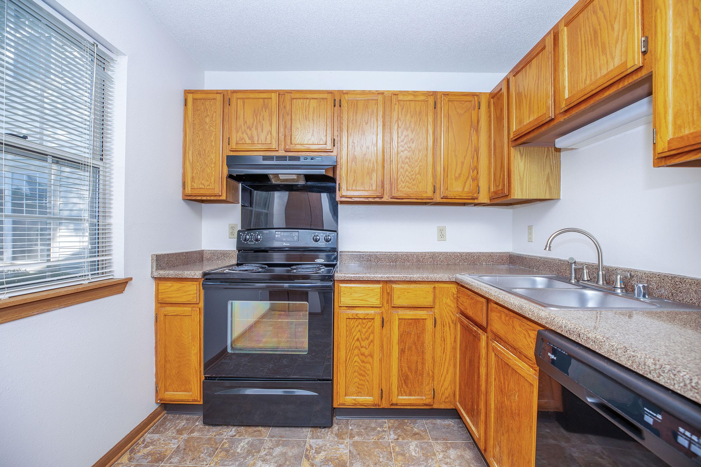 a kitchen with wooden cabinets and a microwave