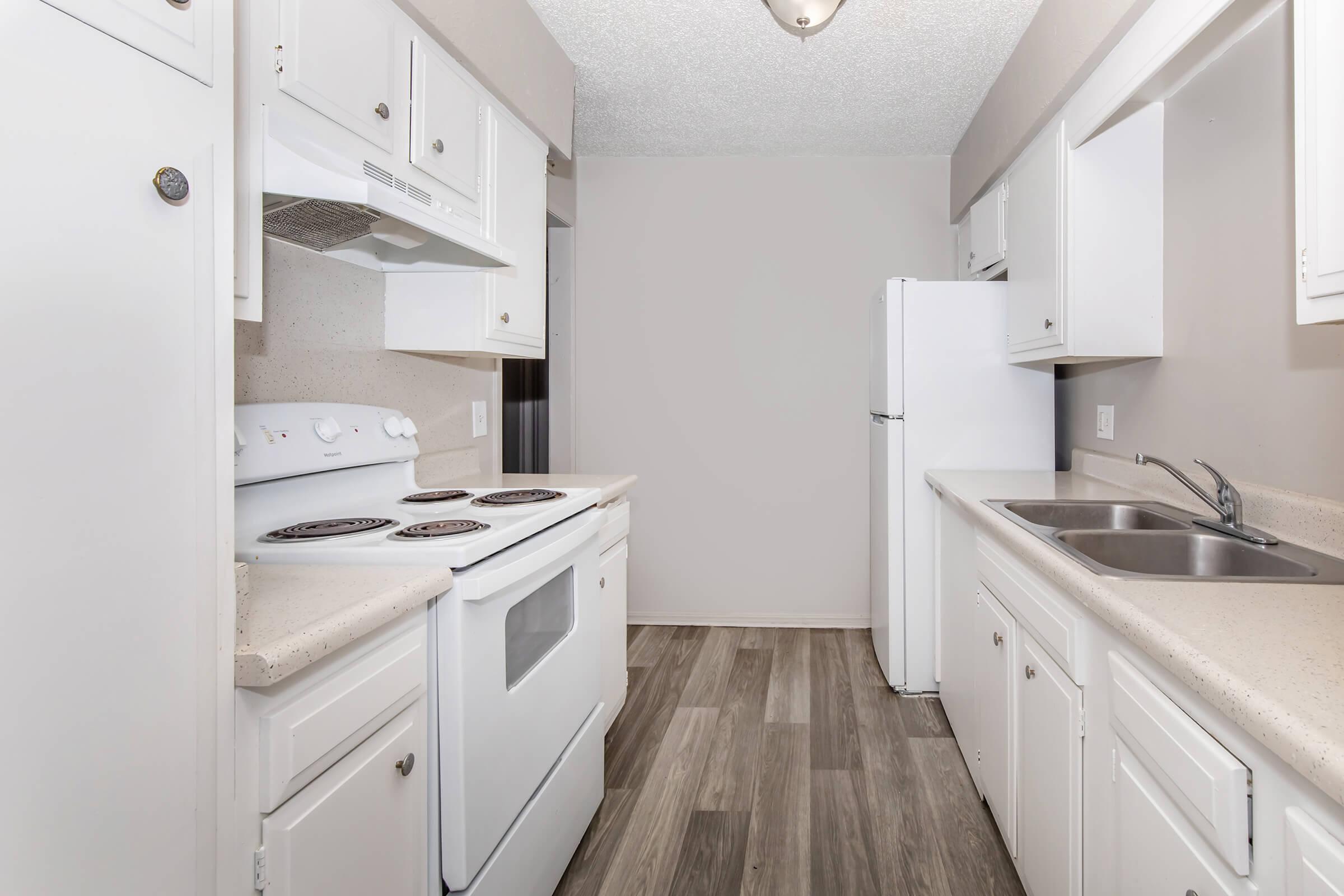 a kitchen with a stove sink and refrigerator