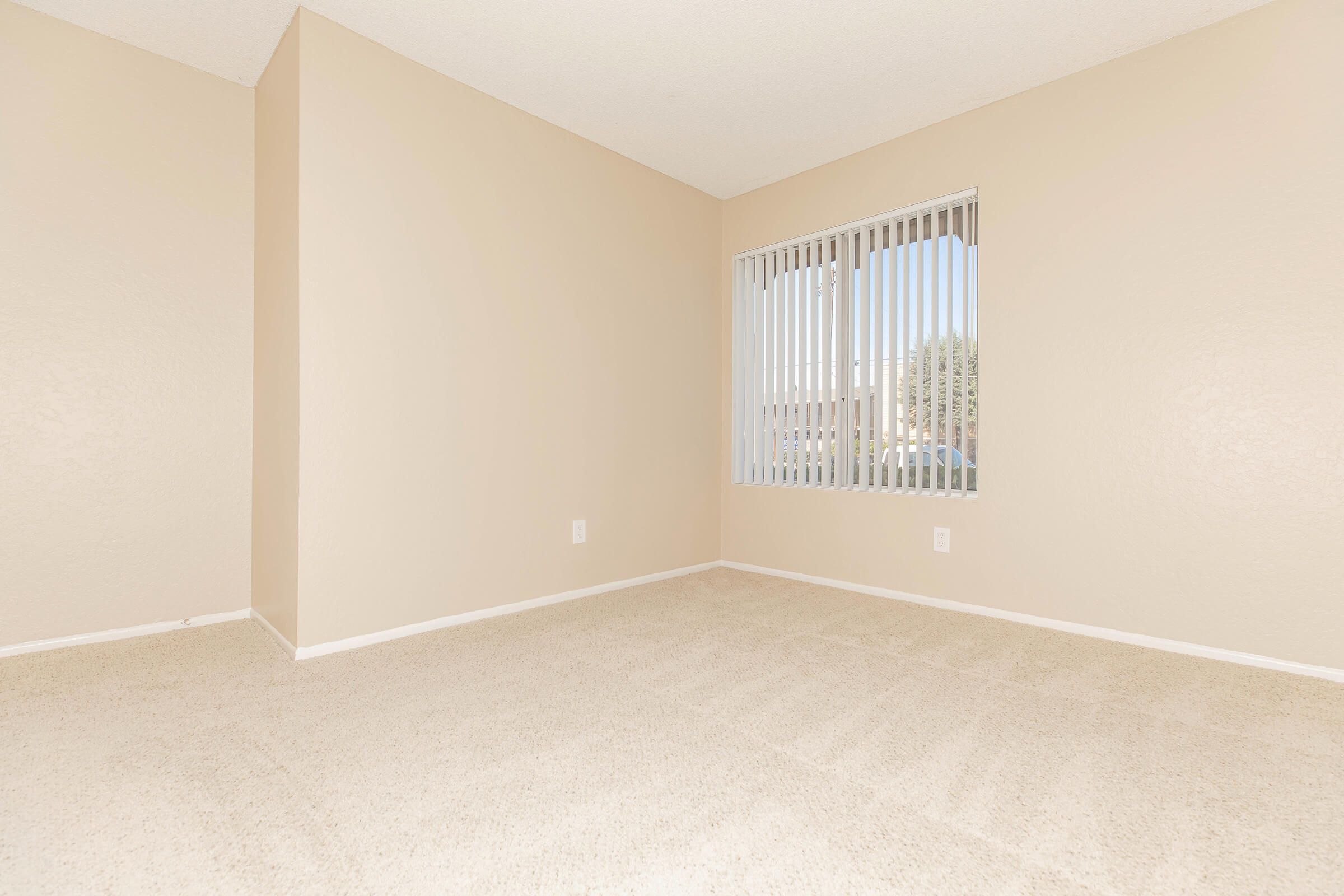Vacant carpeted bedroom 
