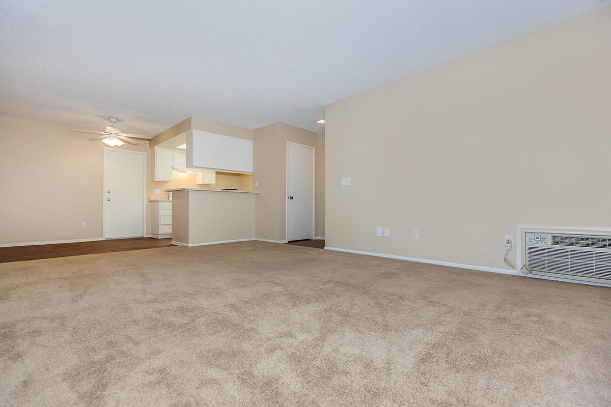 Unfurnished carpeted living room with AC unit