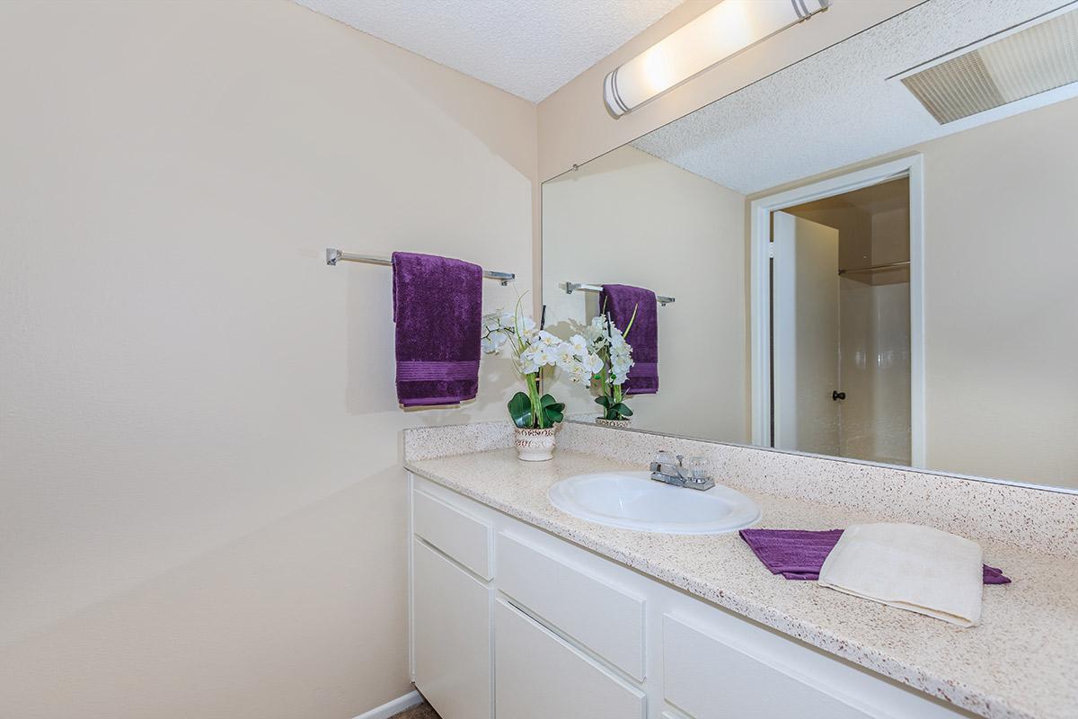 Bathroom sink with purple towels