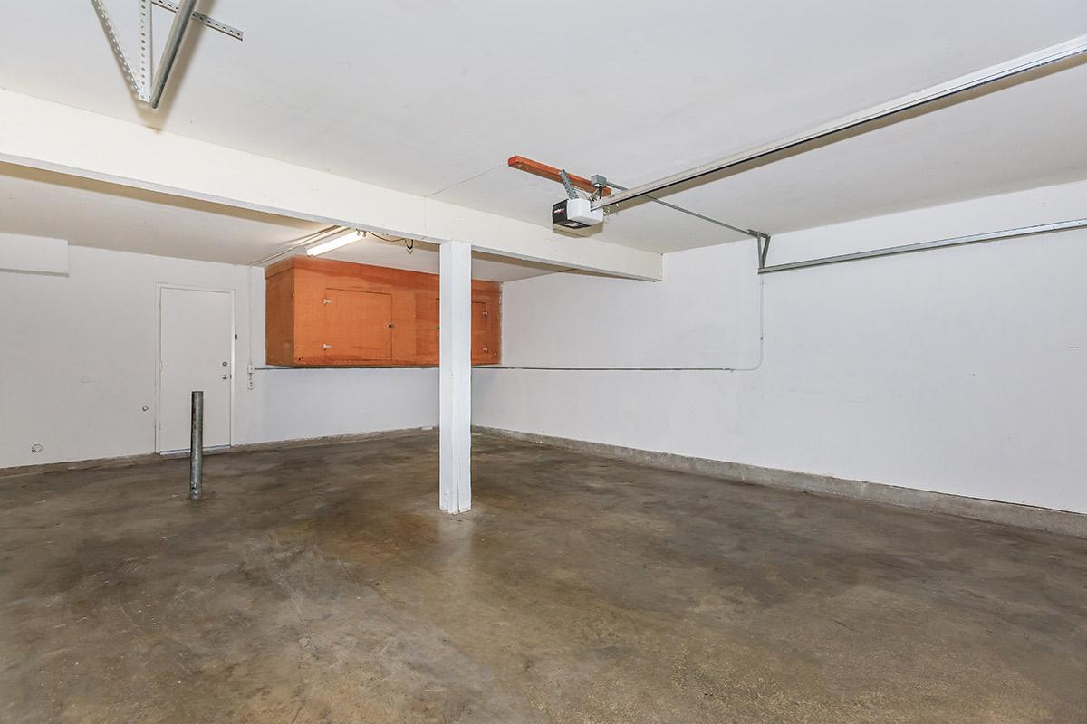 Unfurnished garage with wooden cabinets