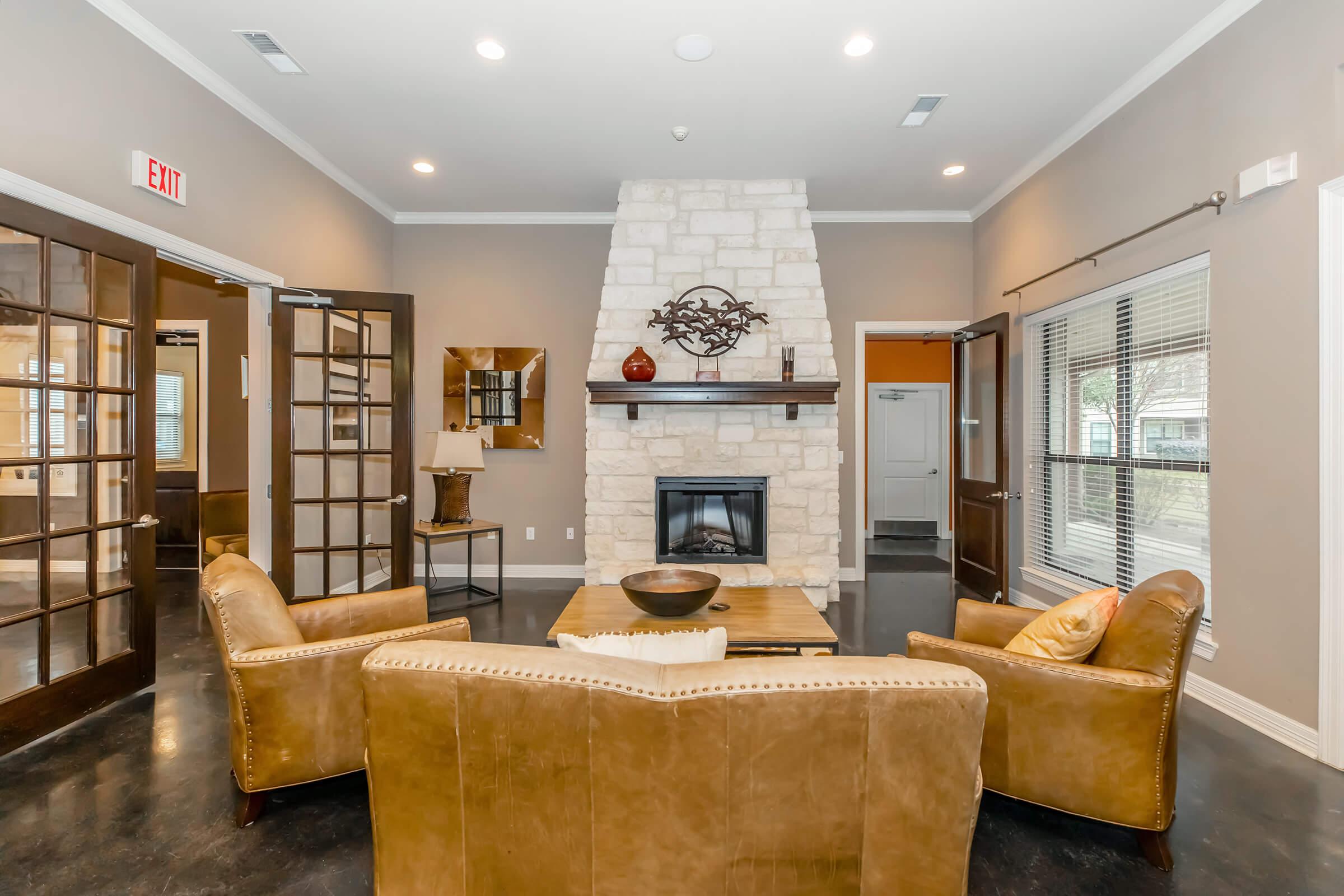 a living room filled with furniture and a fire place