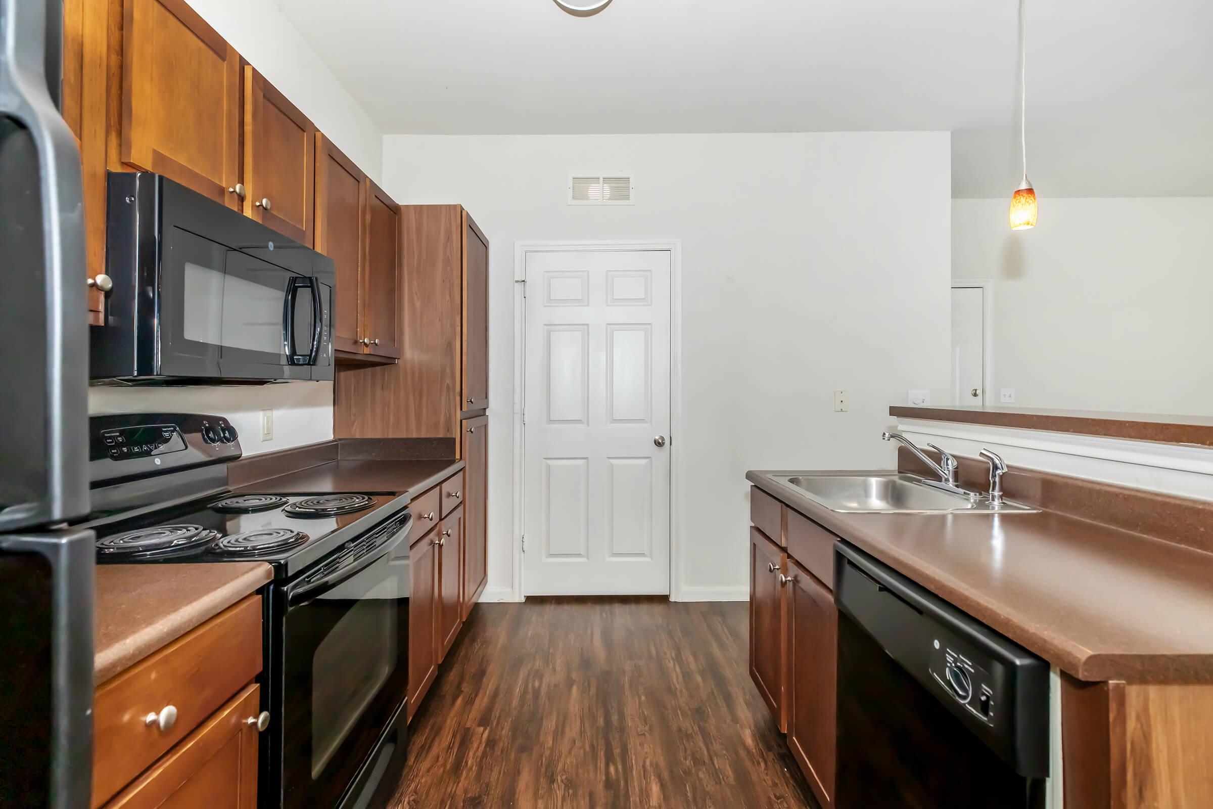 a kitchen with stainless steel appliances and wooden cabinets