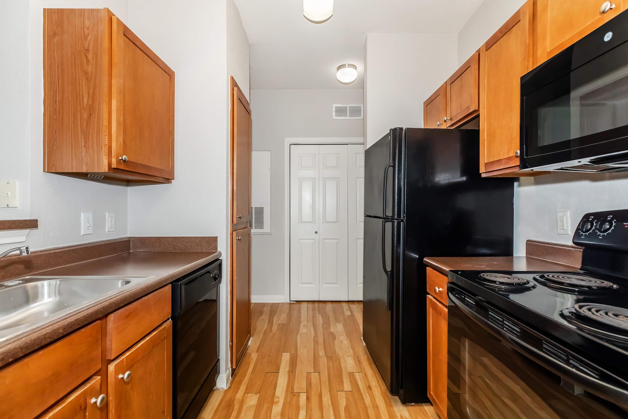 a kitchen with stainless steel appliances and wooden cabinets