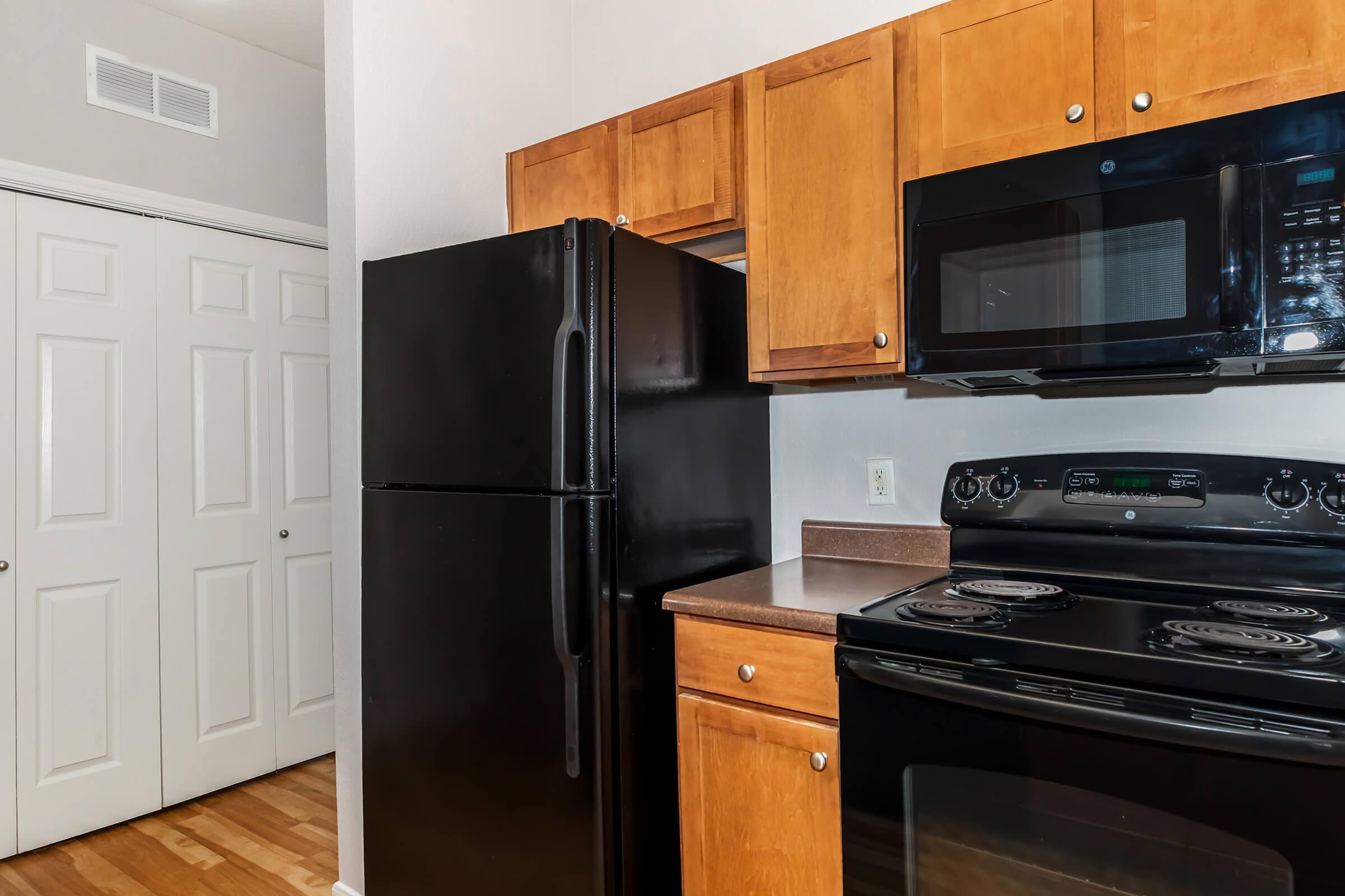 a kitchen with stainless steel appliances and wooden cabinets