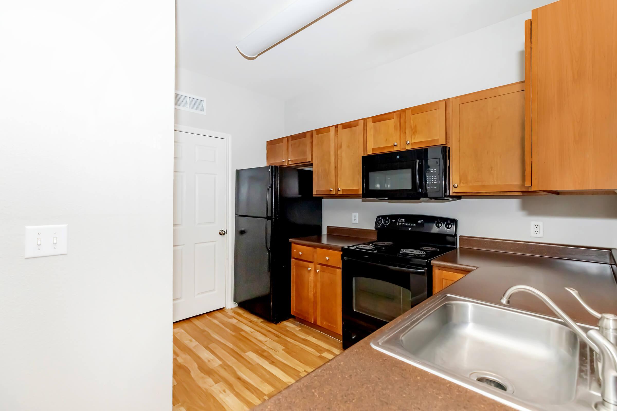 a kitchen with stainless steel appliances and wooden cabinets