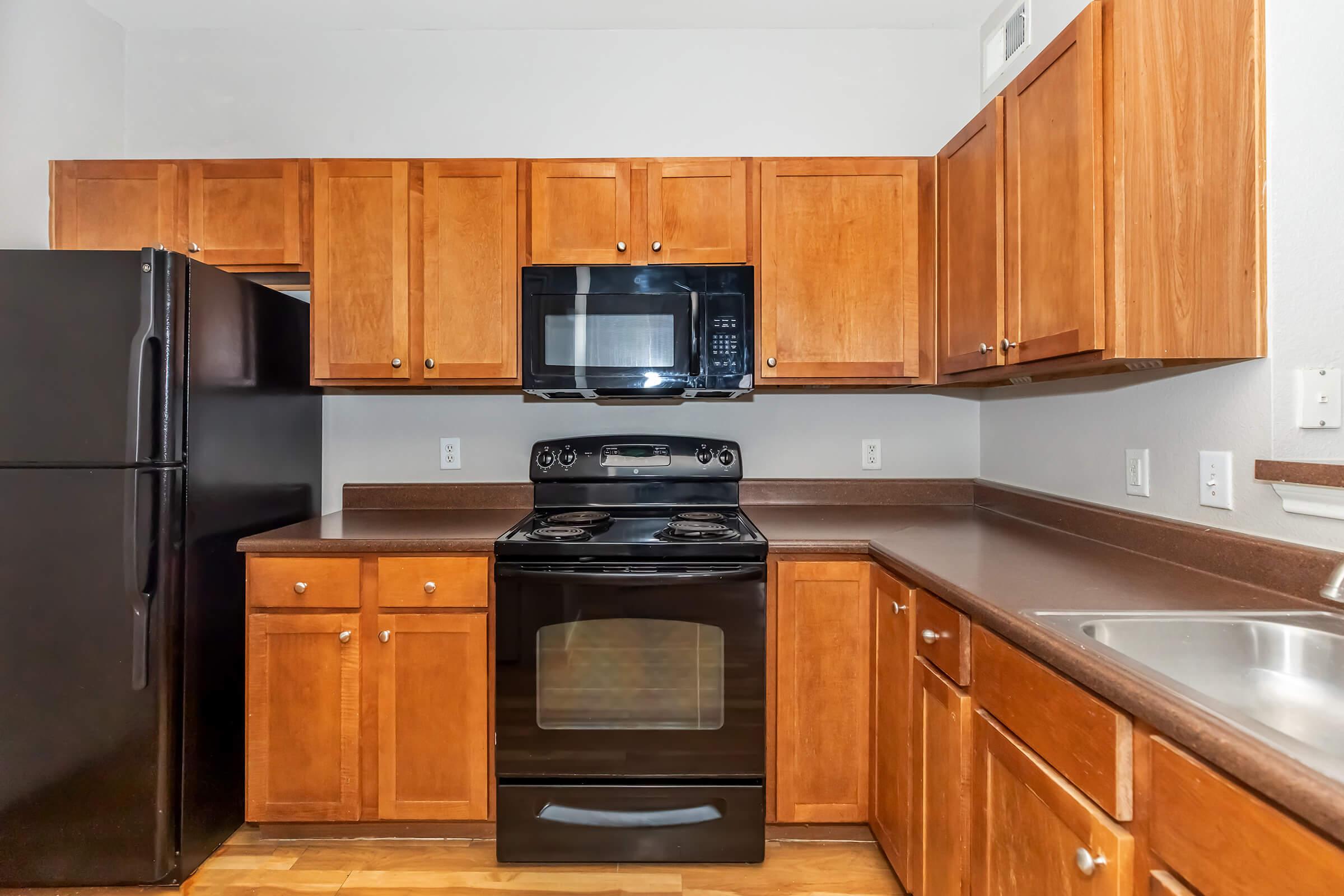 a kitchen with stainless steel appliances and wooden cabinets