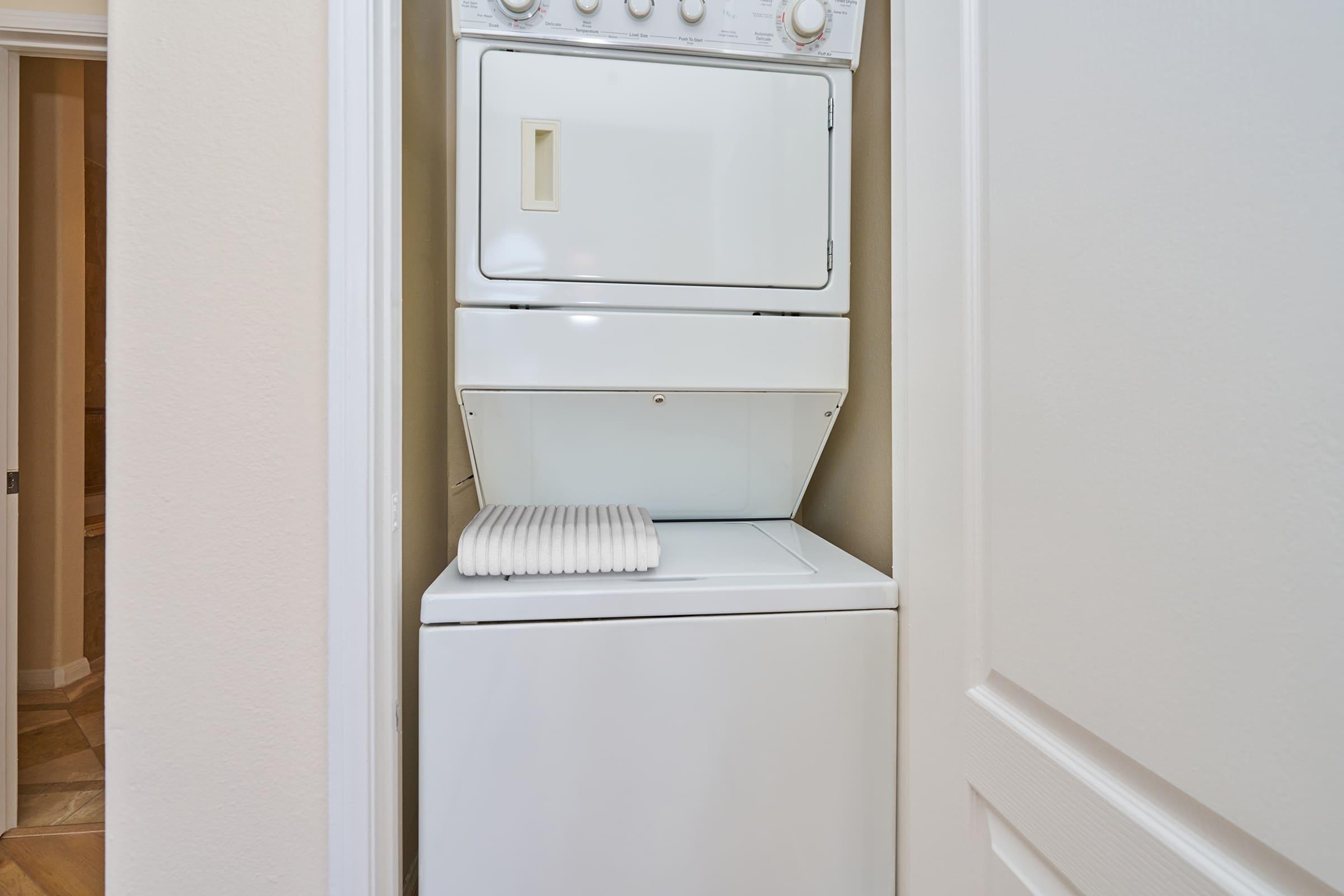 a microwave oven sitting on top of a refrigerator