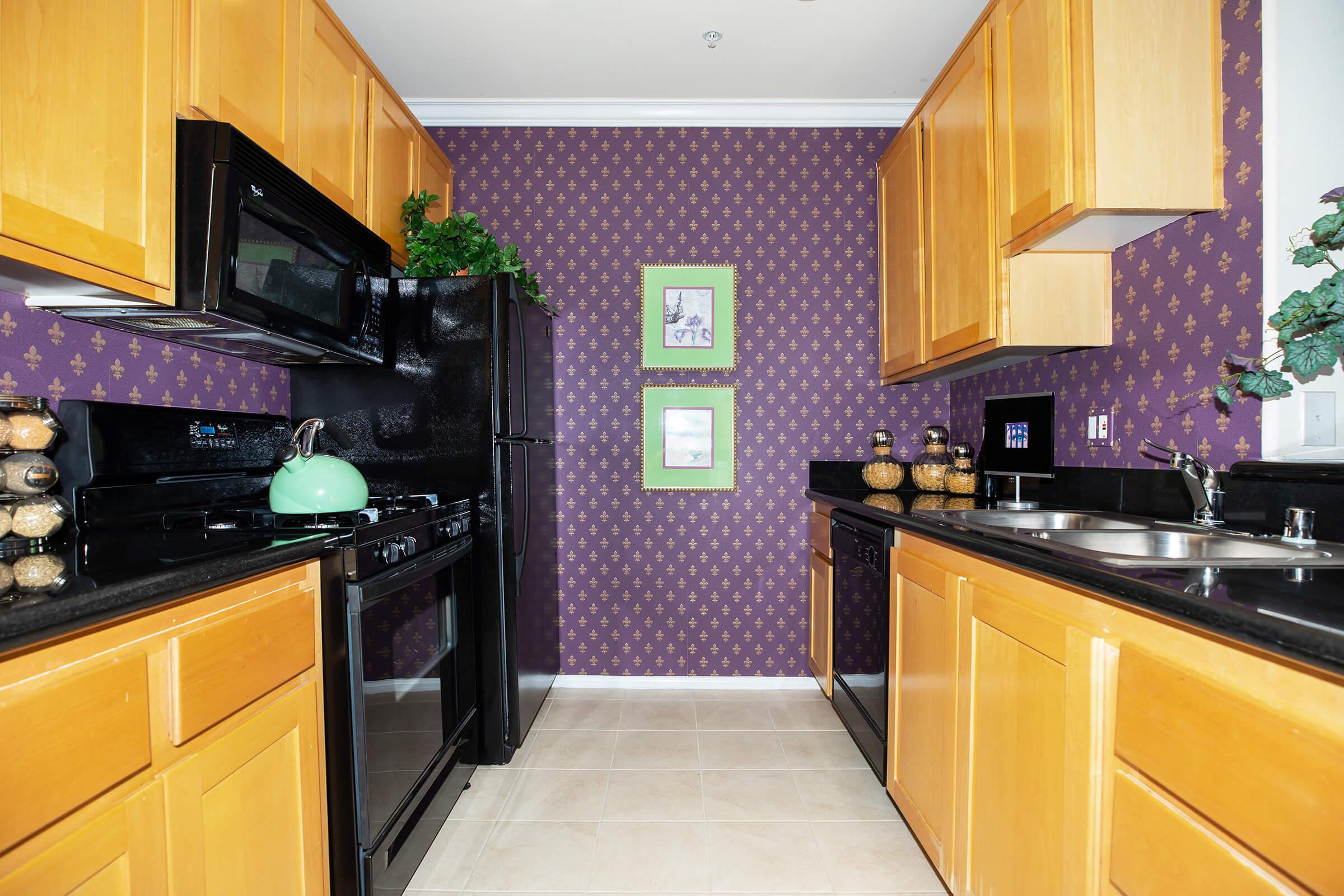 a kitchen with stainless steel appliances and wooden cabinets