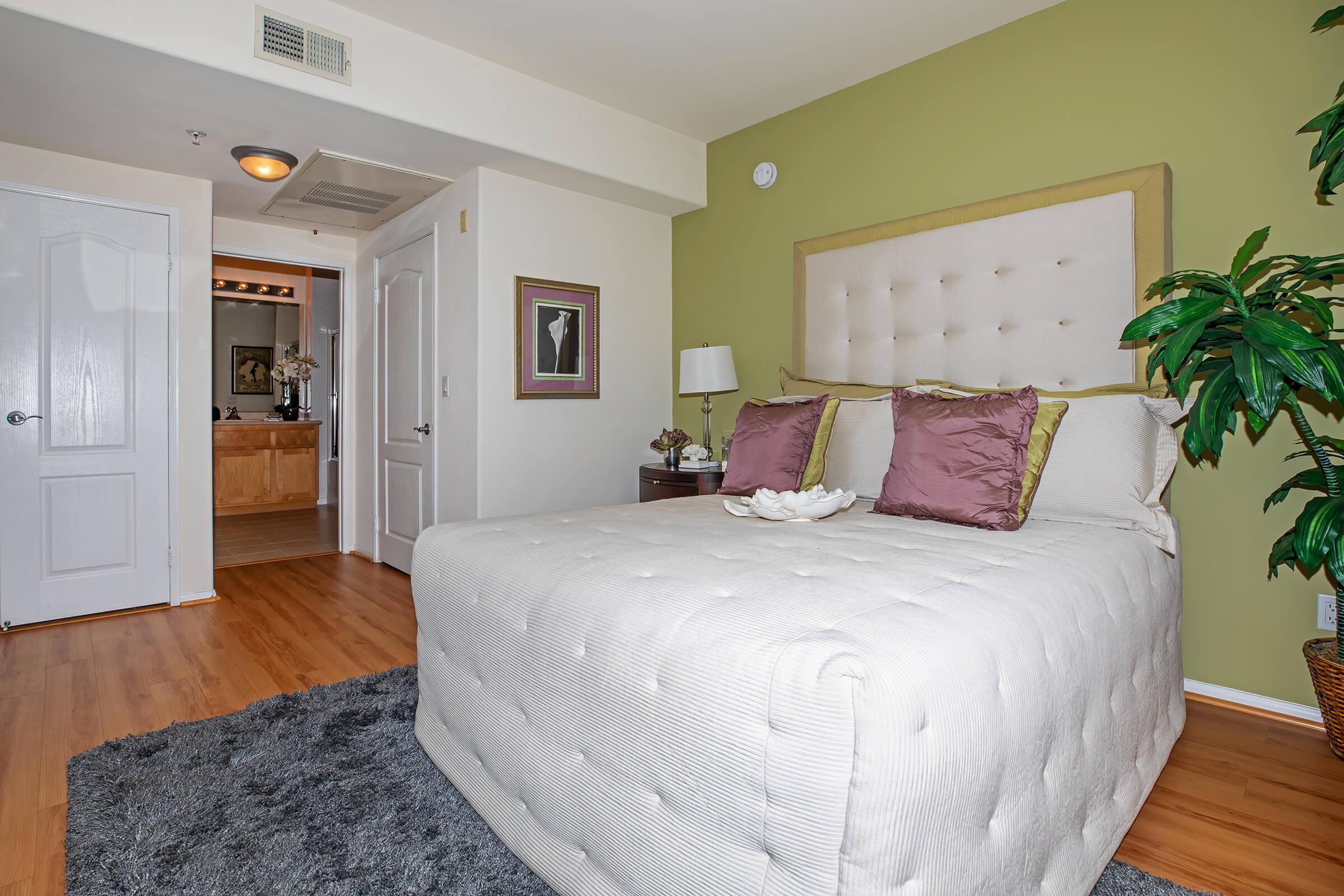 a bedroom with a large bed in a room