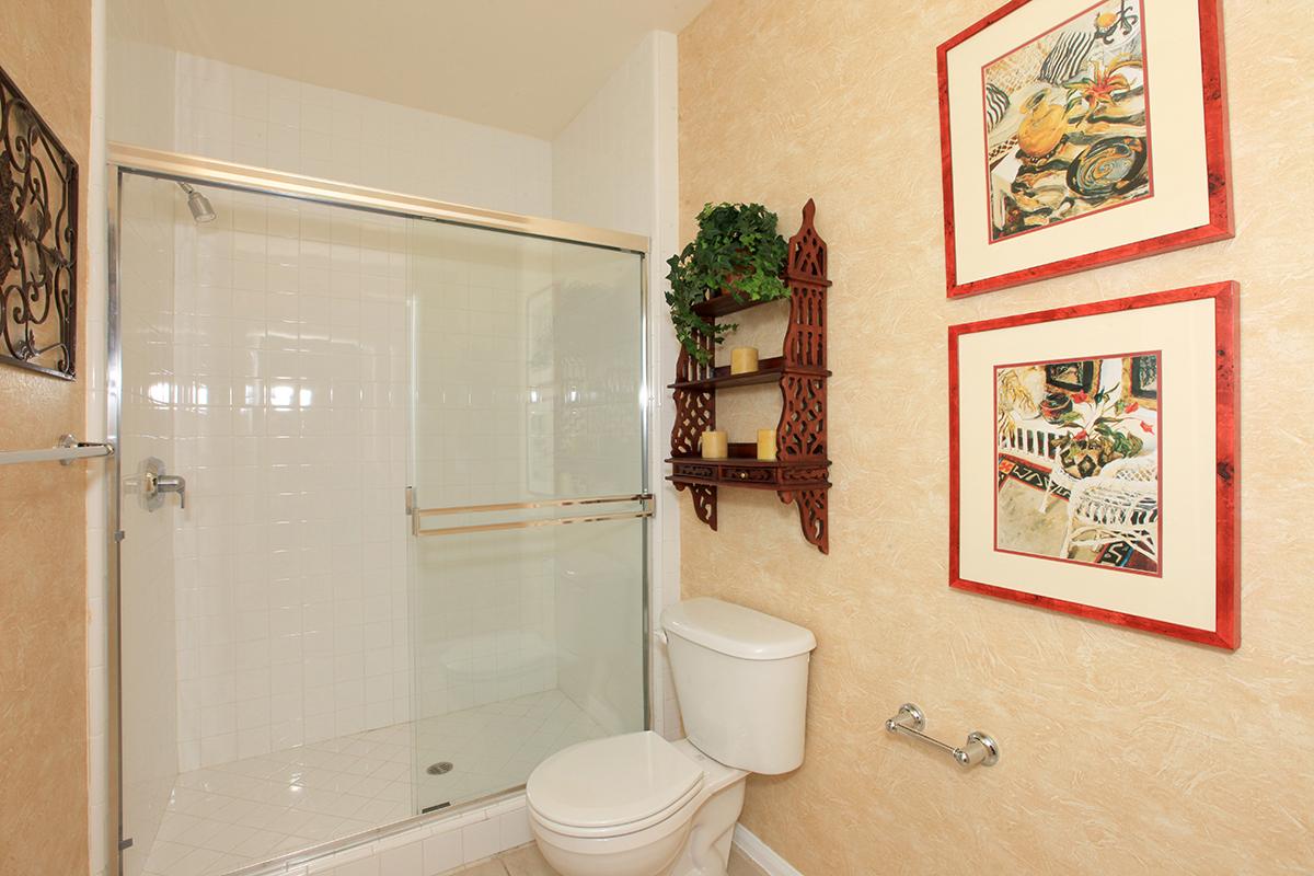 a white tub sitting next to a shower
