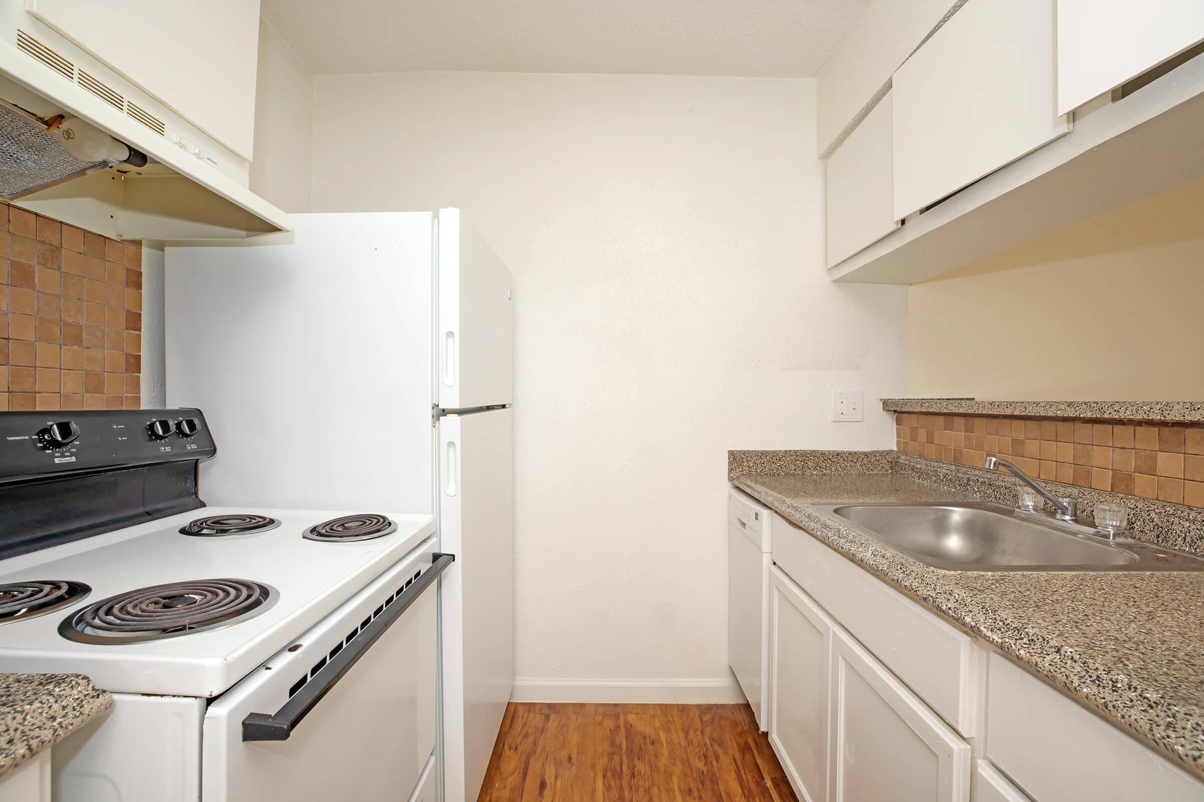 a stove top oven sitting inside of a kitchen