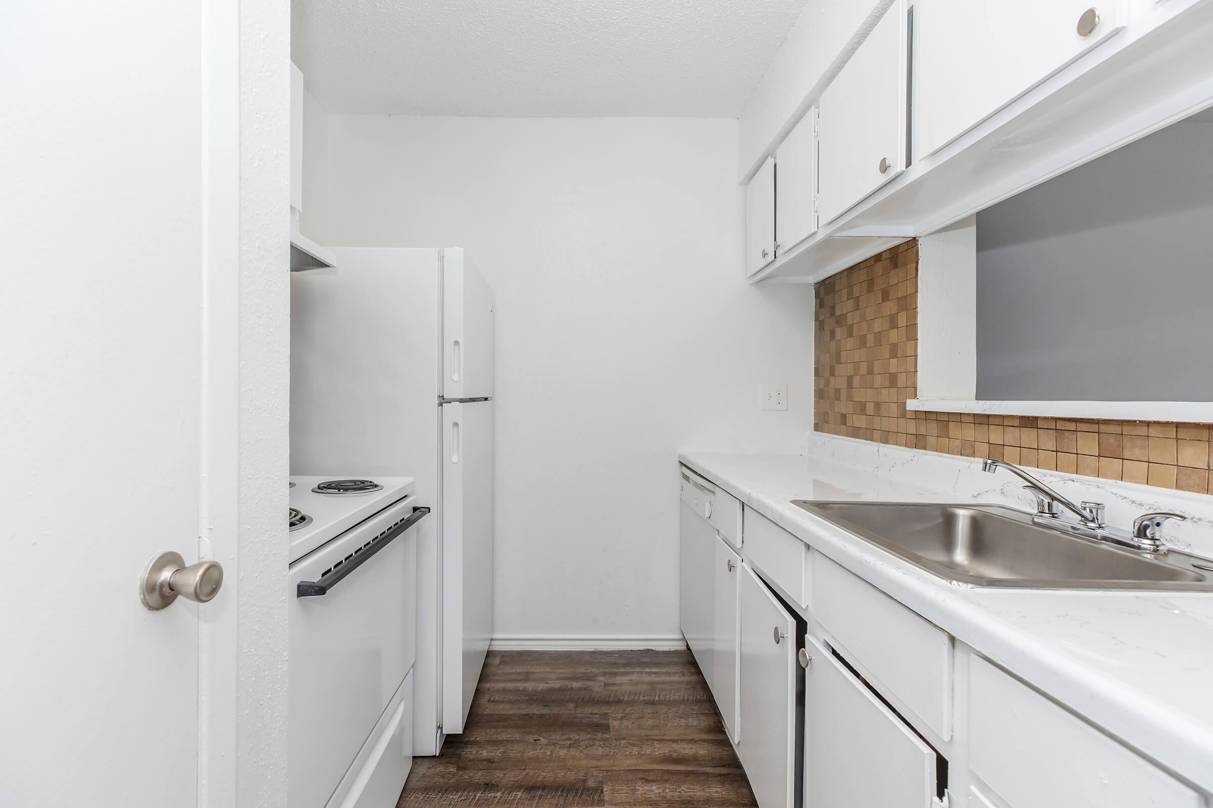 a kitchen with a sink and a mirror