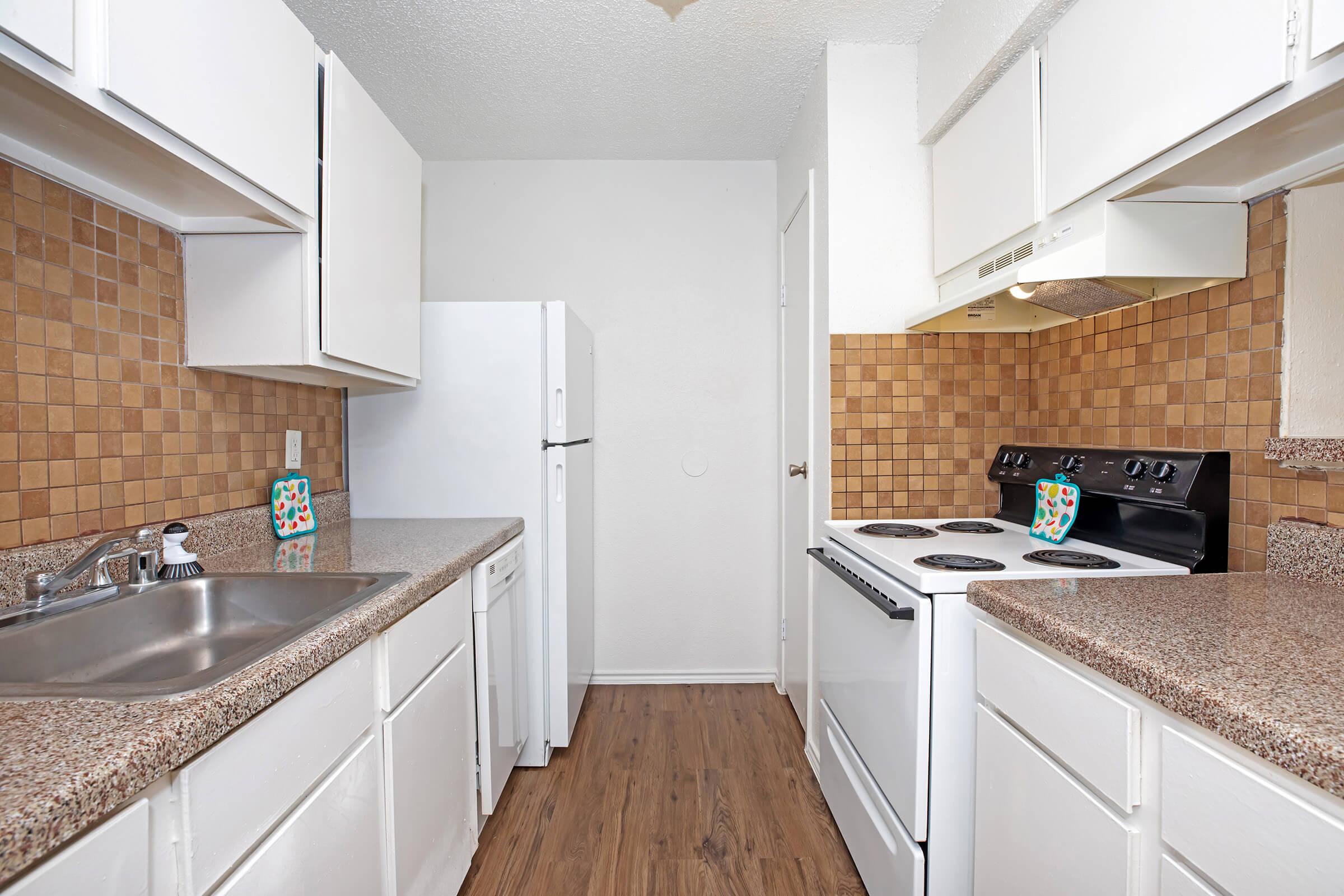 a kitchen with a stove and a sink