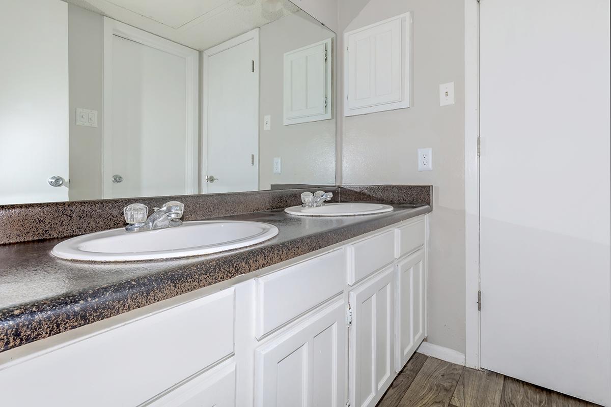 a kitchen with a sink and a mirror