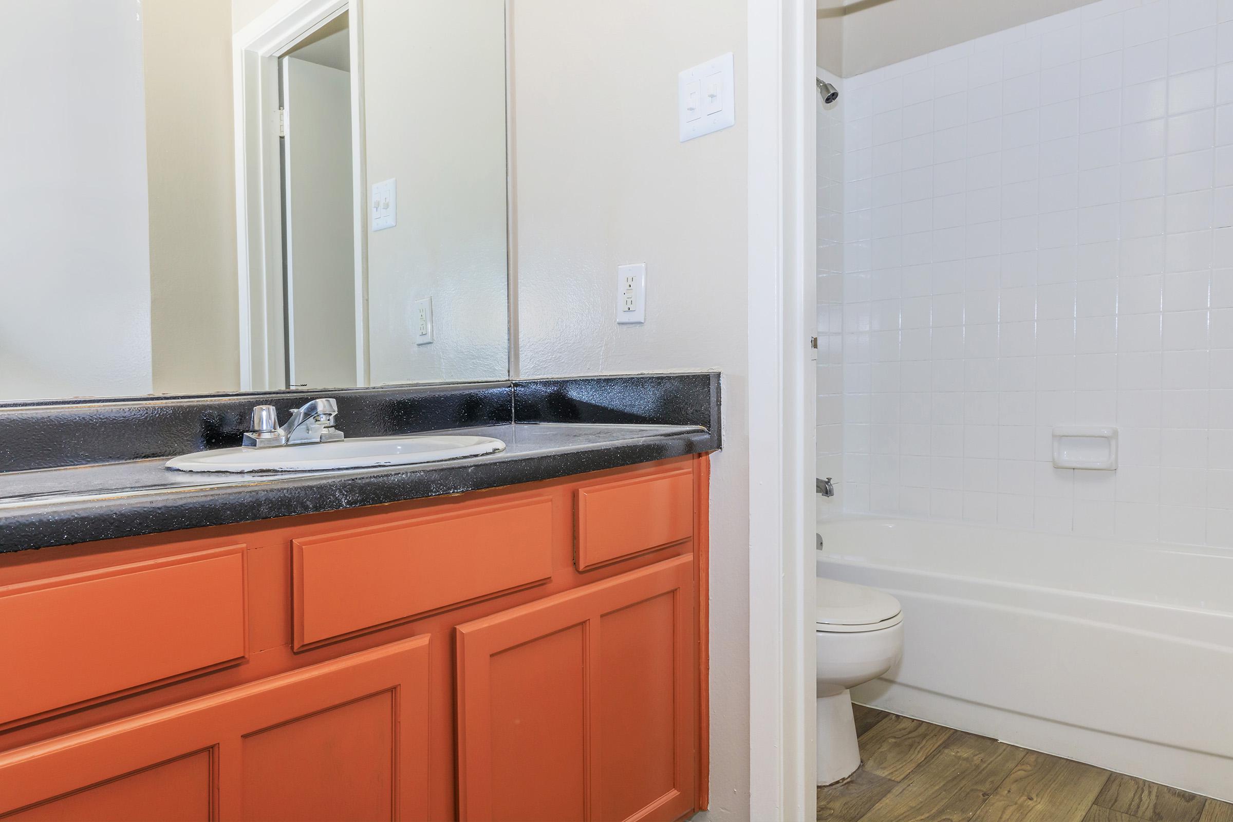 a kitchen with a sink and a mirror