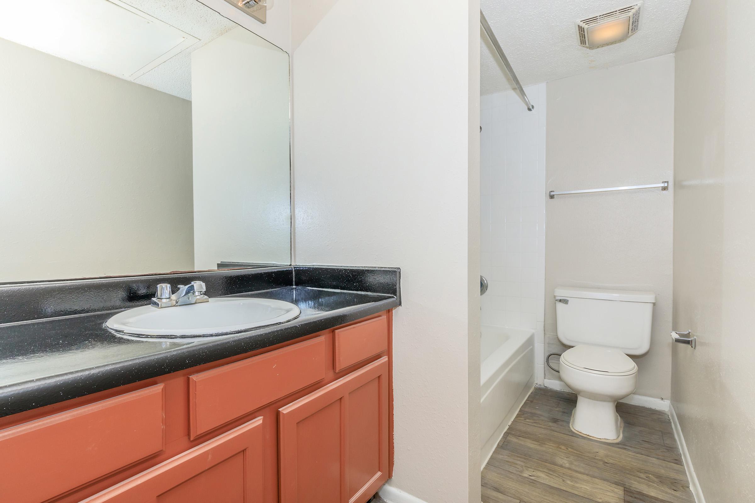 a kitchen with a sink and a mirror