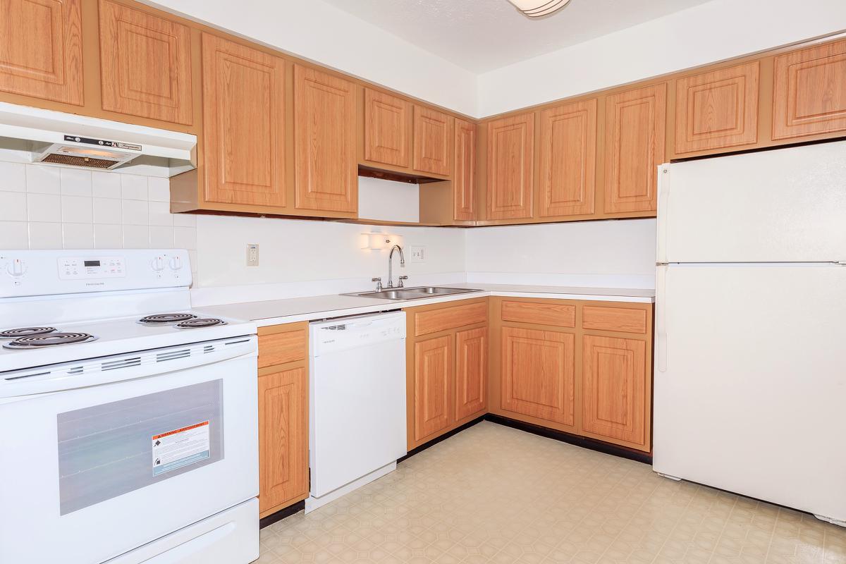 a kitchen with a stove and a refrigerator