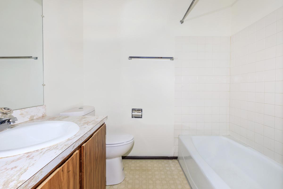 a large white tub next to a sink